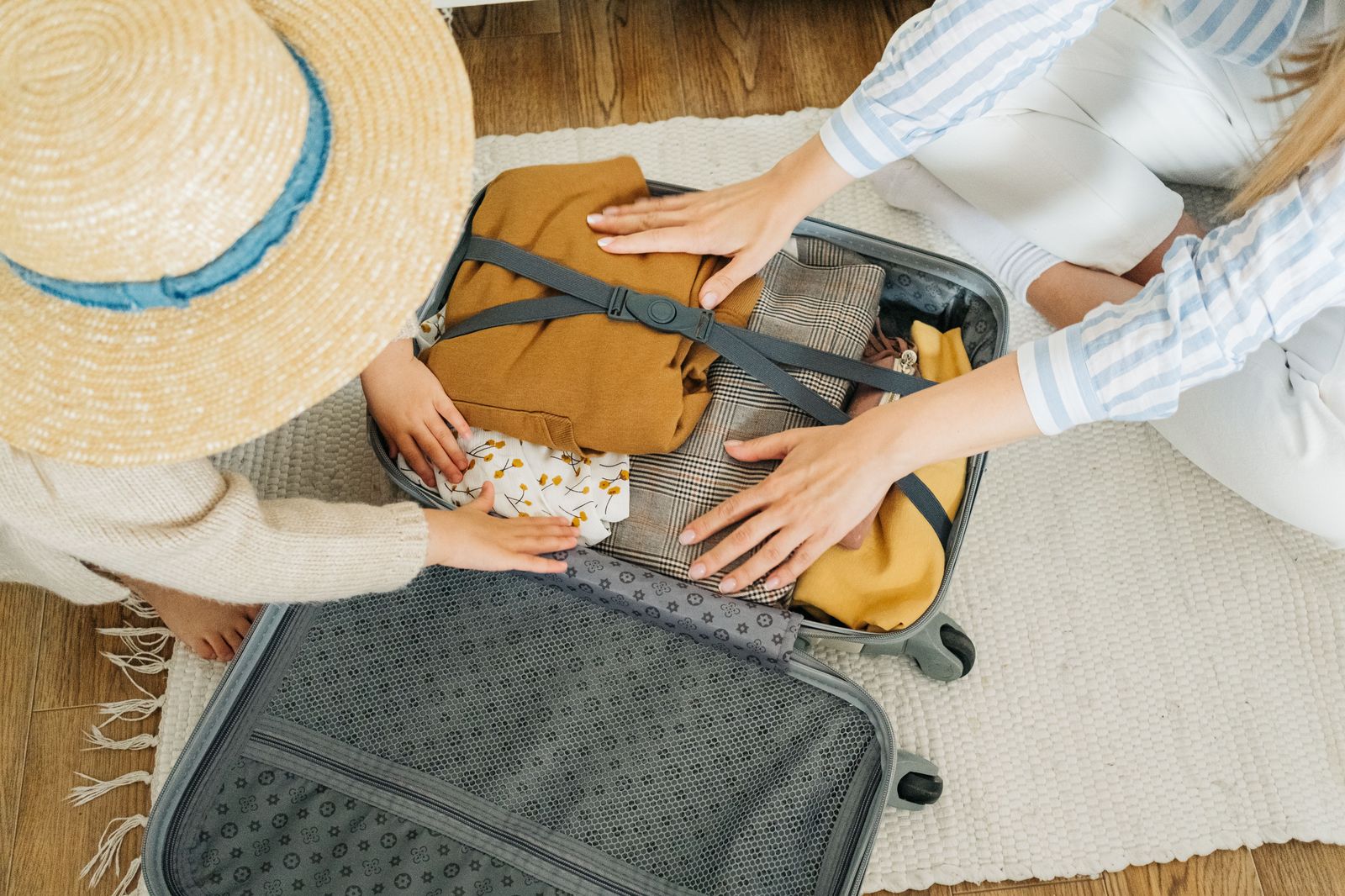 A family with suitcases setting off on a beach holiday