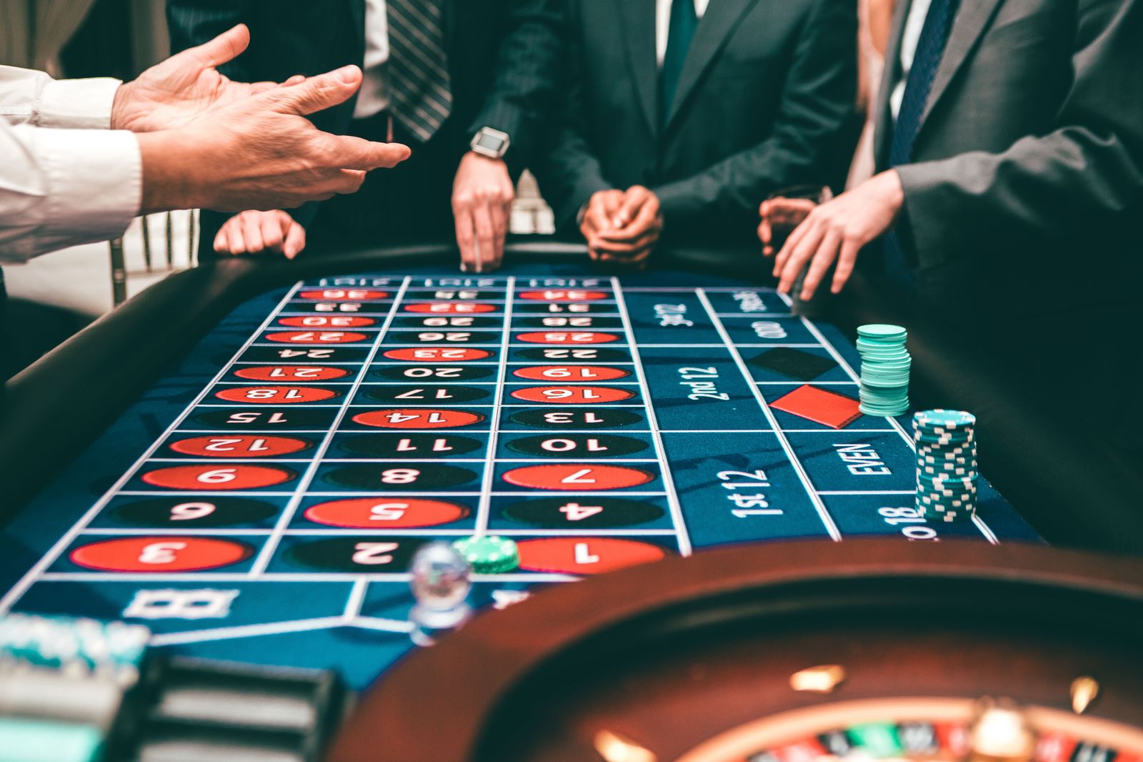Chips stacked beside a roulette table on a casino floor