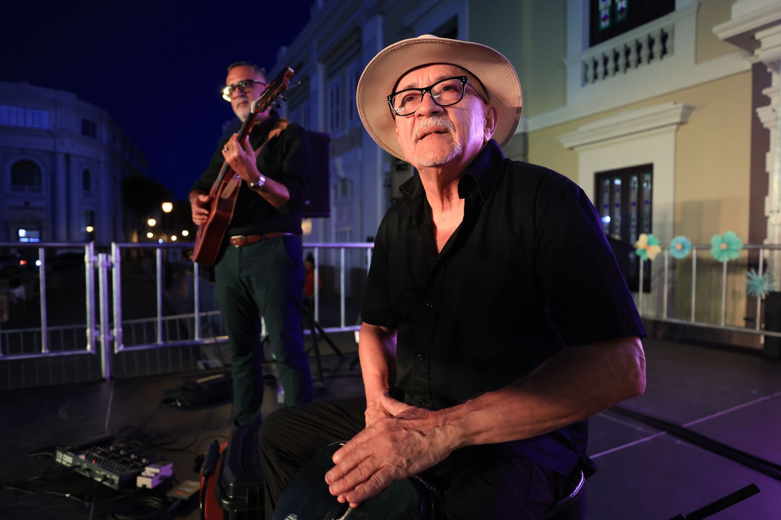 A street musician playing to a crowd on a festival night, typical of Art Crawl evenings on James Street North