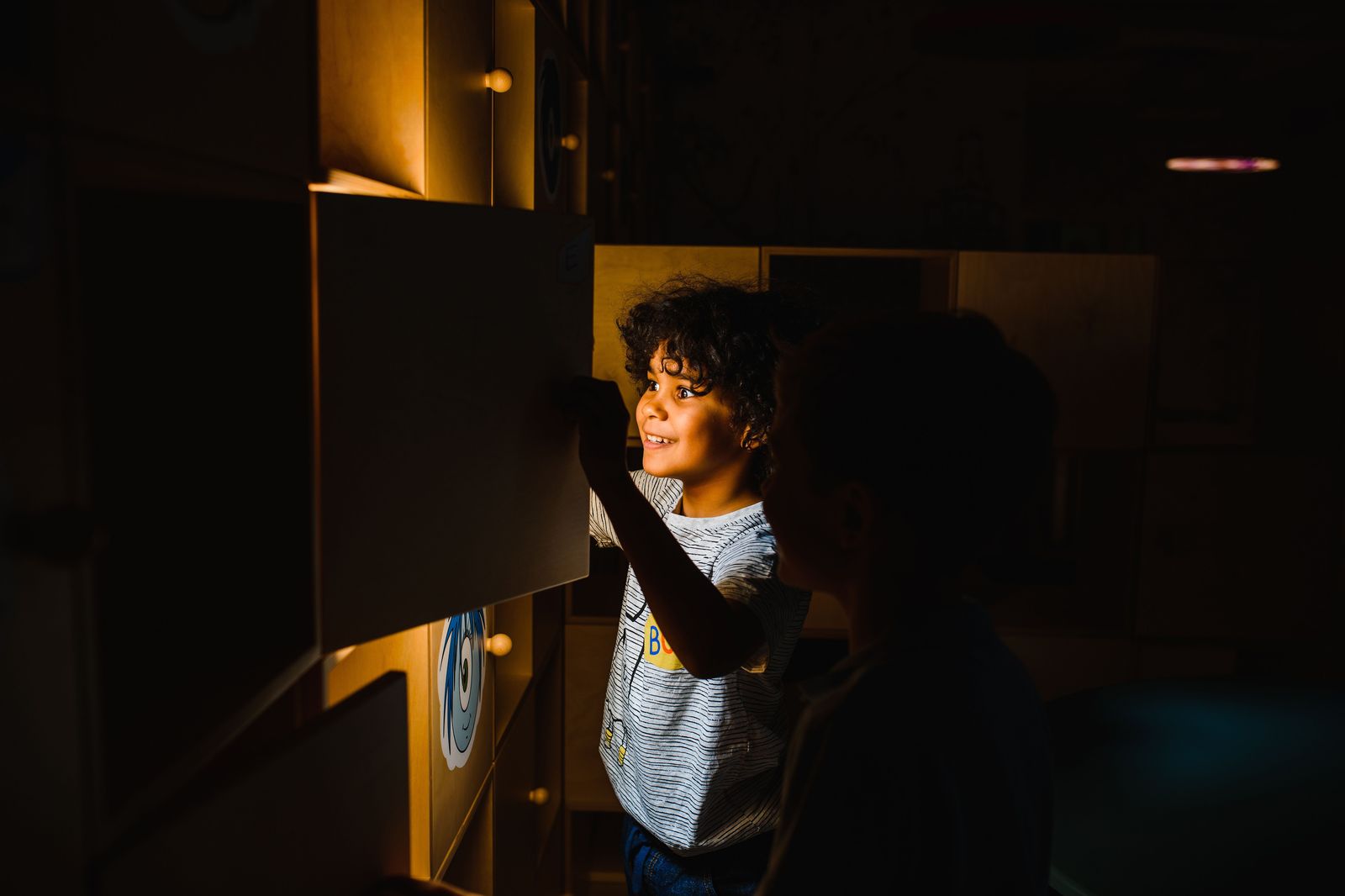 Young children playing at an interactive museum exhibit, the style of the Hamilton Children's Museum in Gage Park