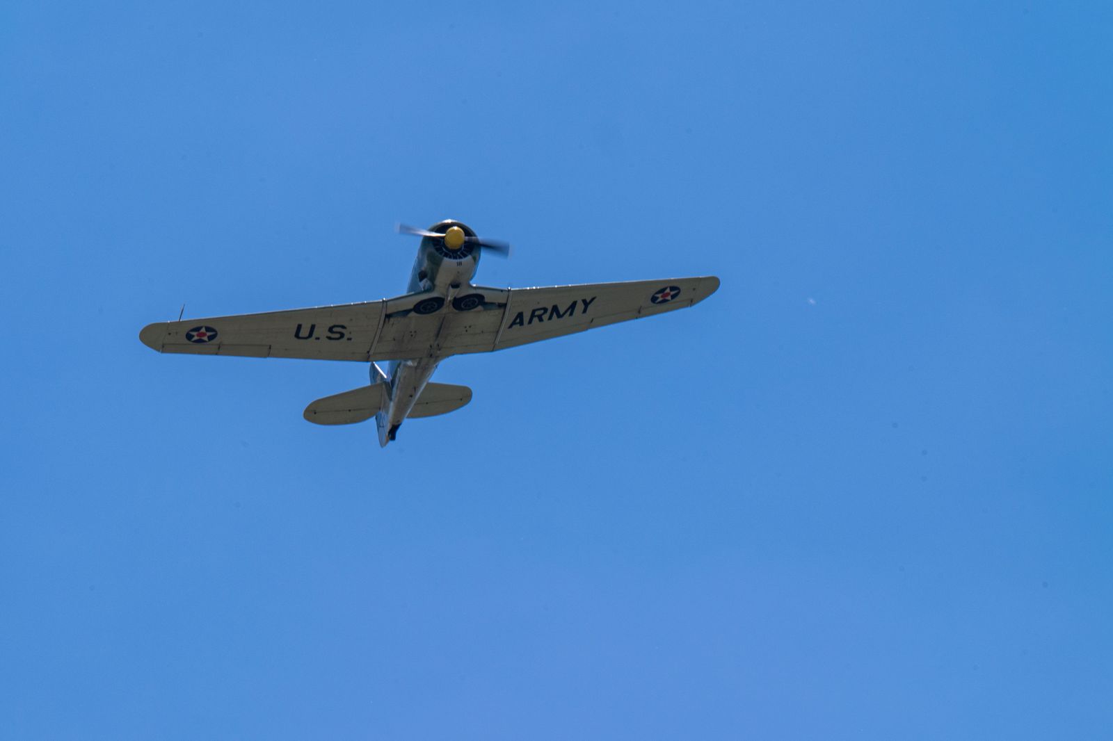 A vintage propeller warplane in flight, the kind of aircraft the Canadian Warplane Heritage Museum keeps airworthy