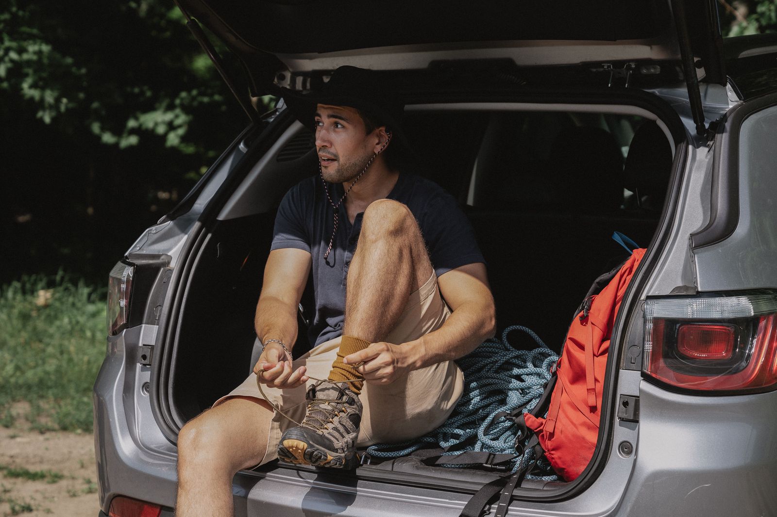 A family loads bags into a car before a road trip across the border to Canada