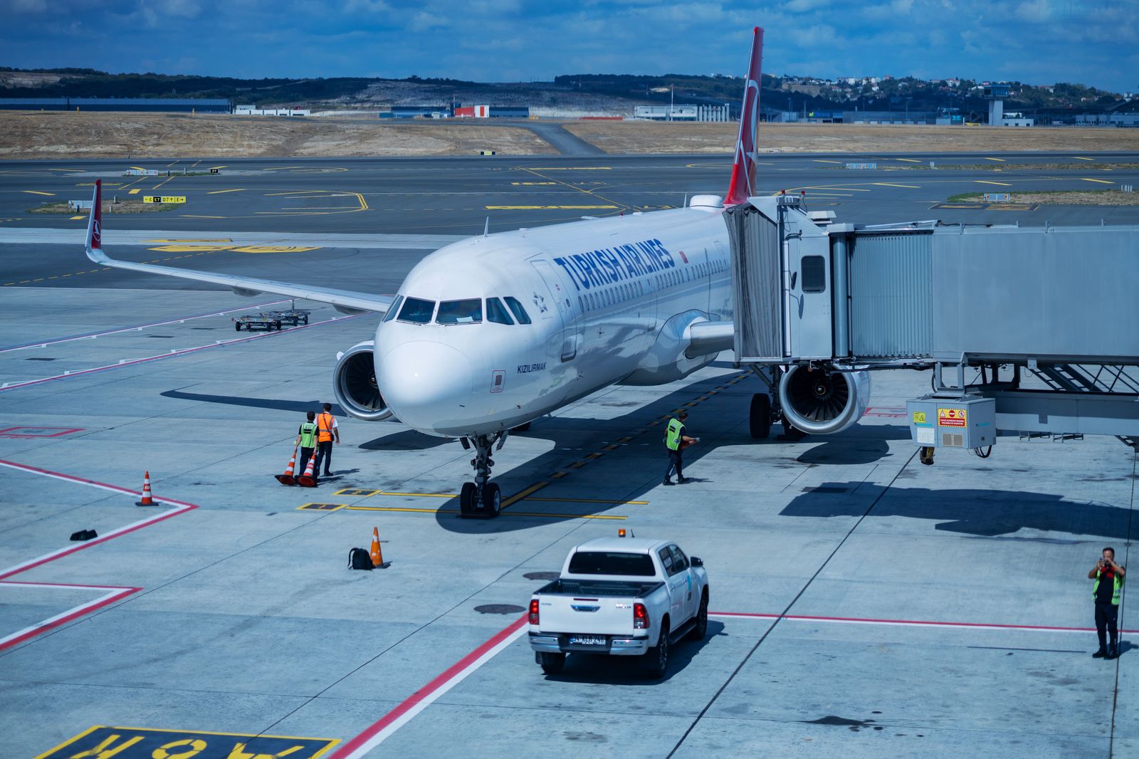 Travellers being collected at an airport terminal curb