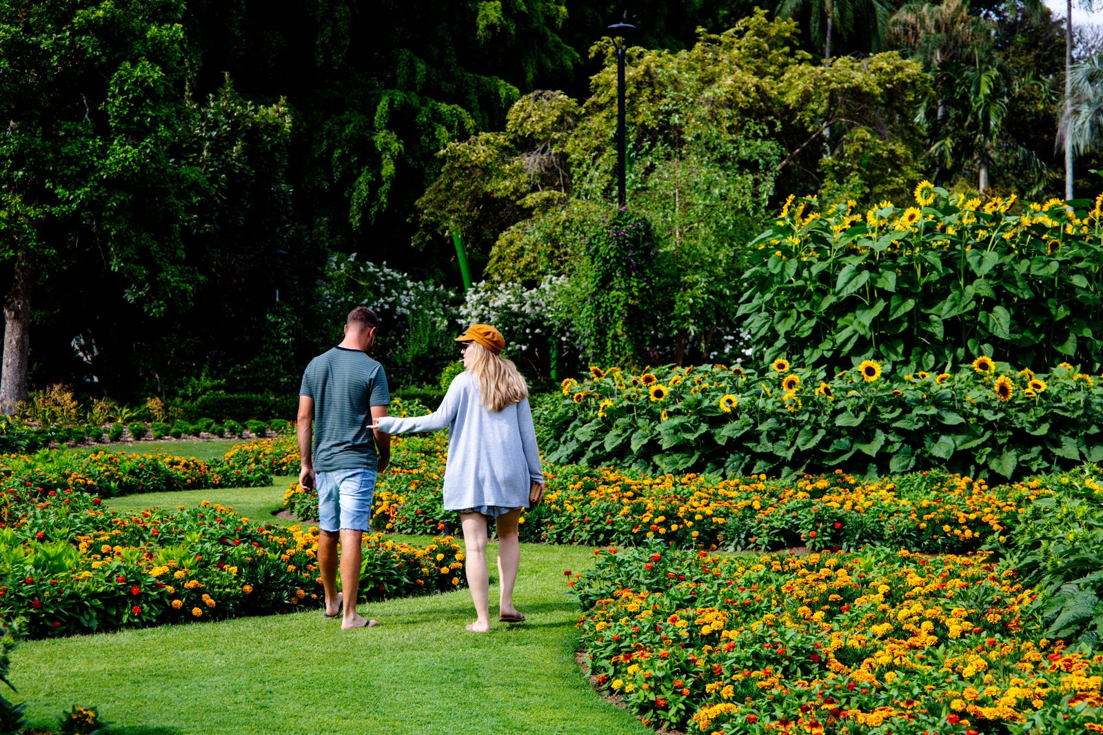 A couple walking through a flower garden on their anniversary