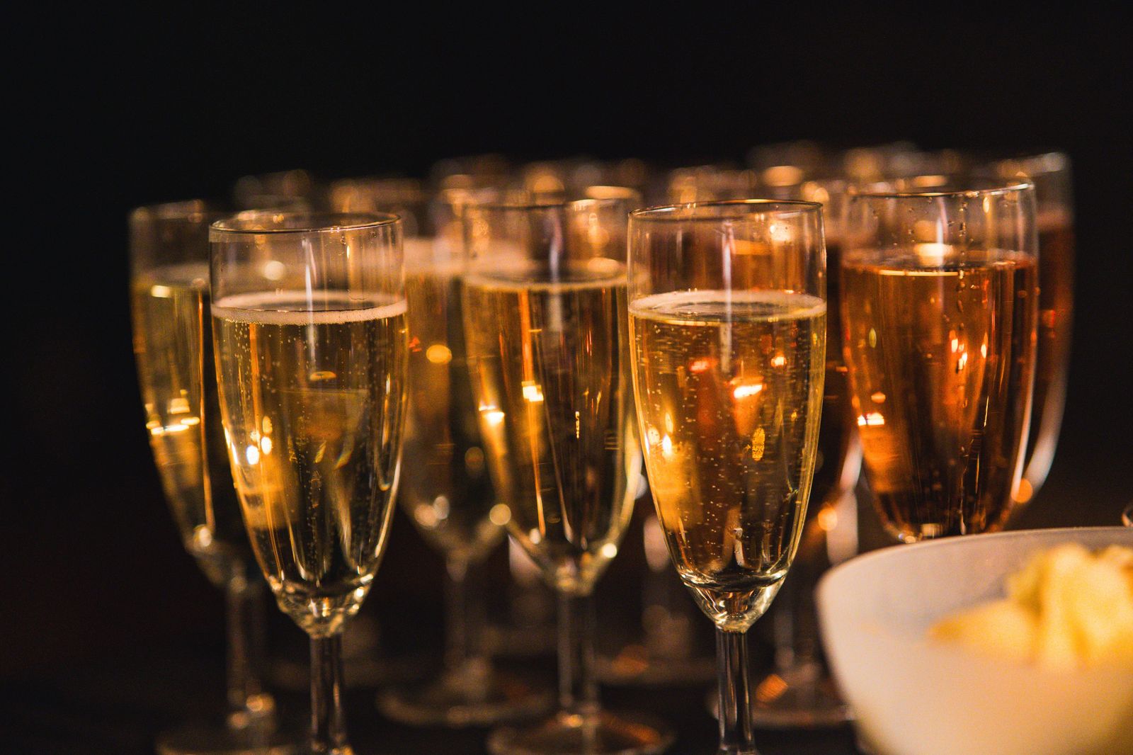Two champagne glasses raised in a toast on an anniversary evening