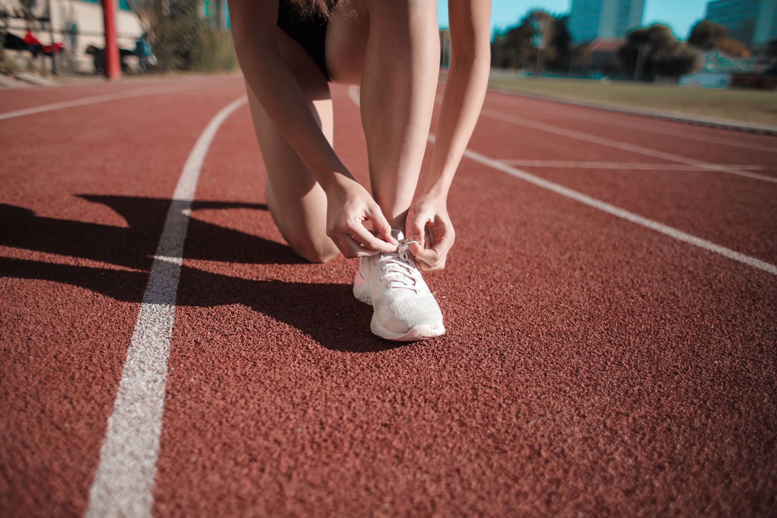 Runner tying racing shoes on an early spring race morning