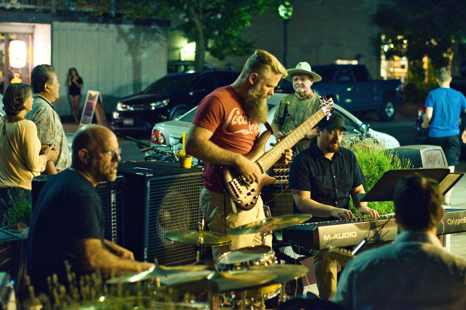 A street musician playing to a crowd on James Street North during a summer Art Crawl