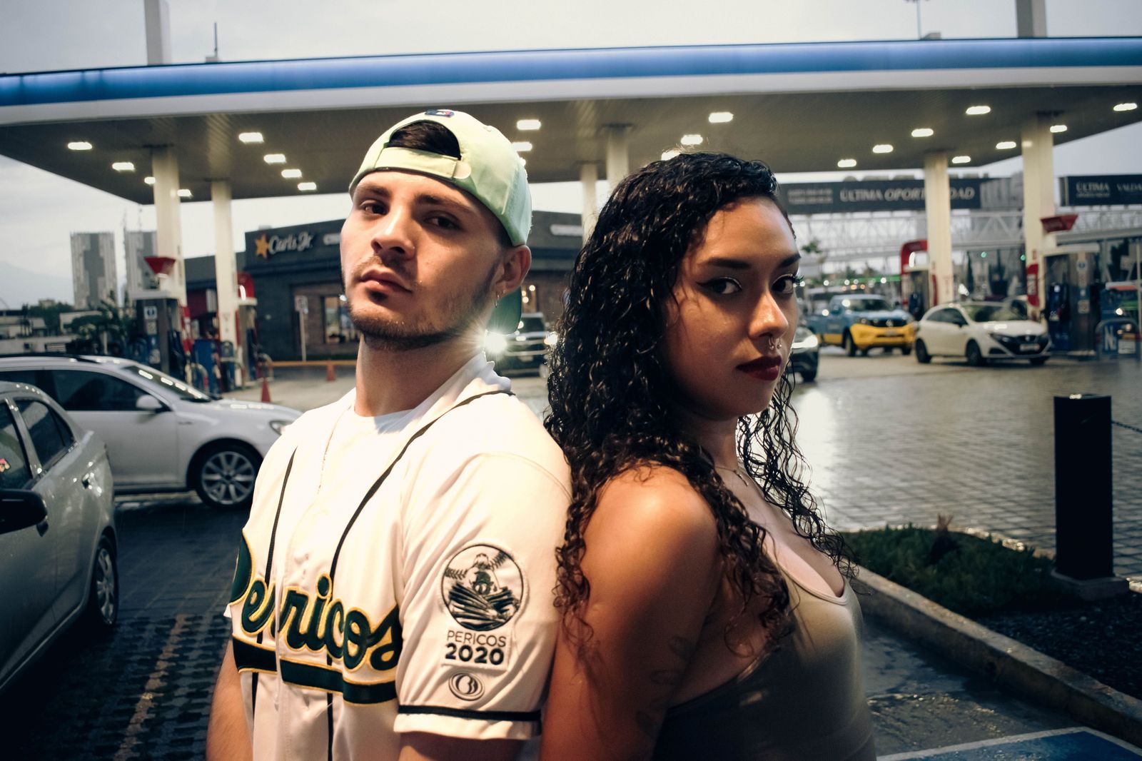 A couple stepping out of a car on a city street for an evening downtown