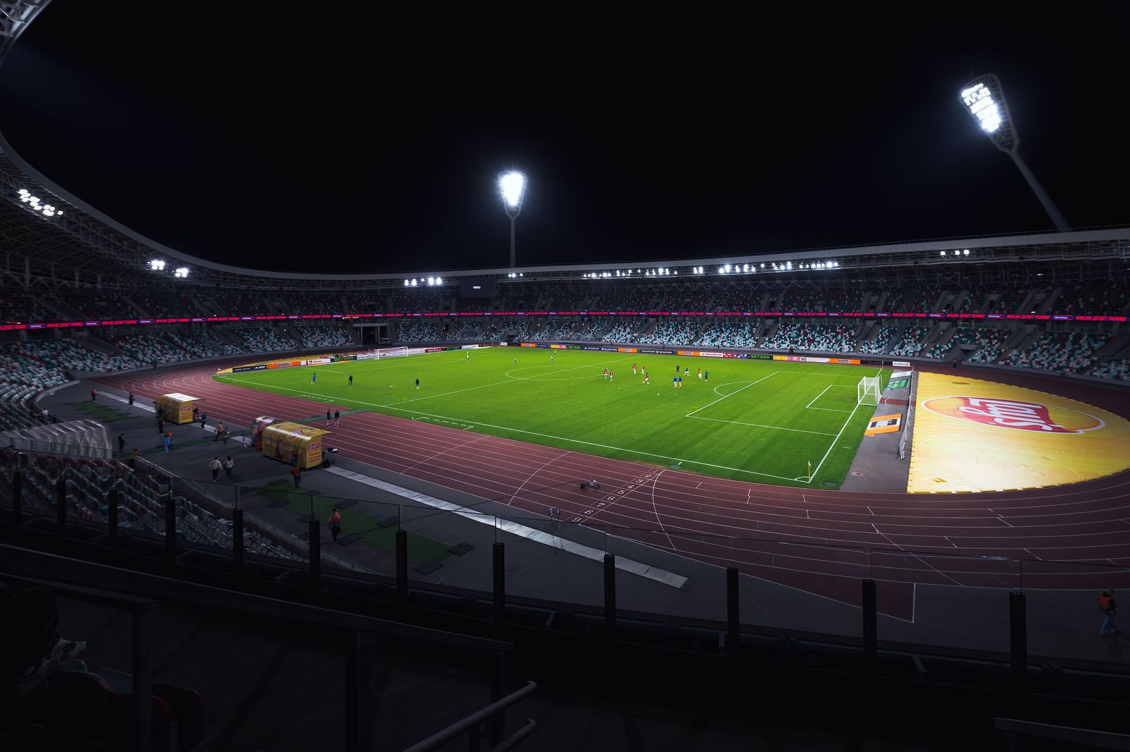 A football stadium under lights at night