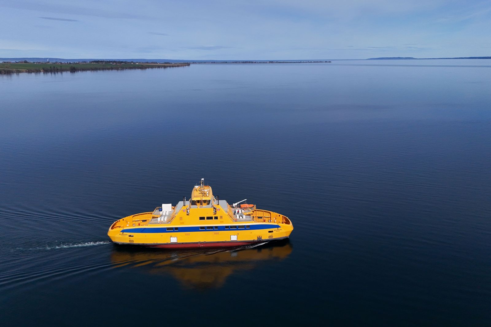 A small passenger and car ferry crosses Lake Erie toward an island