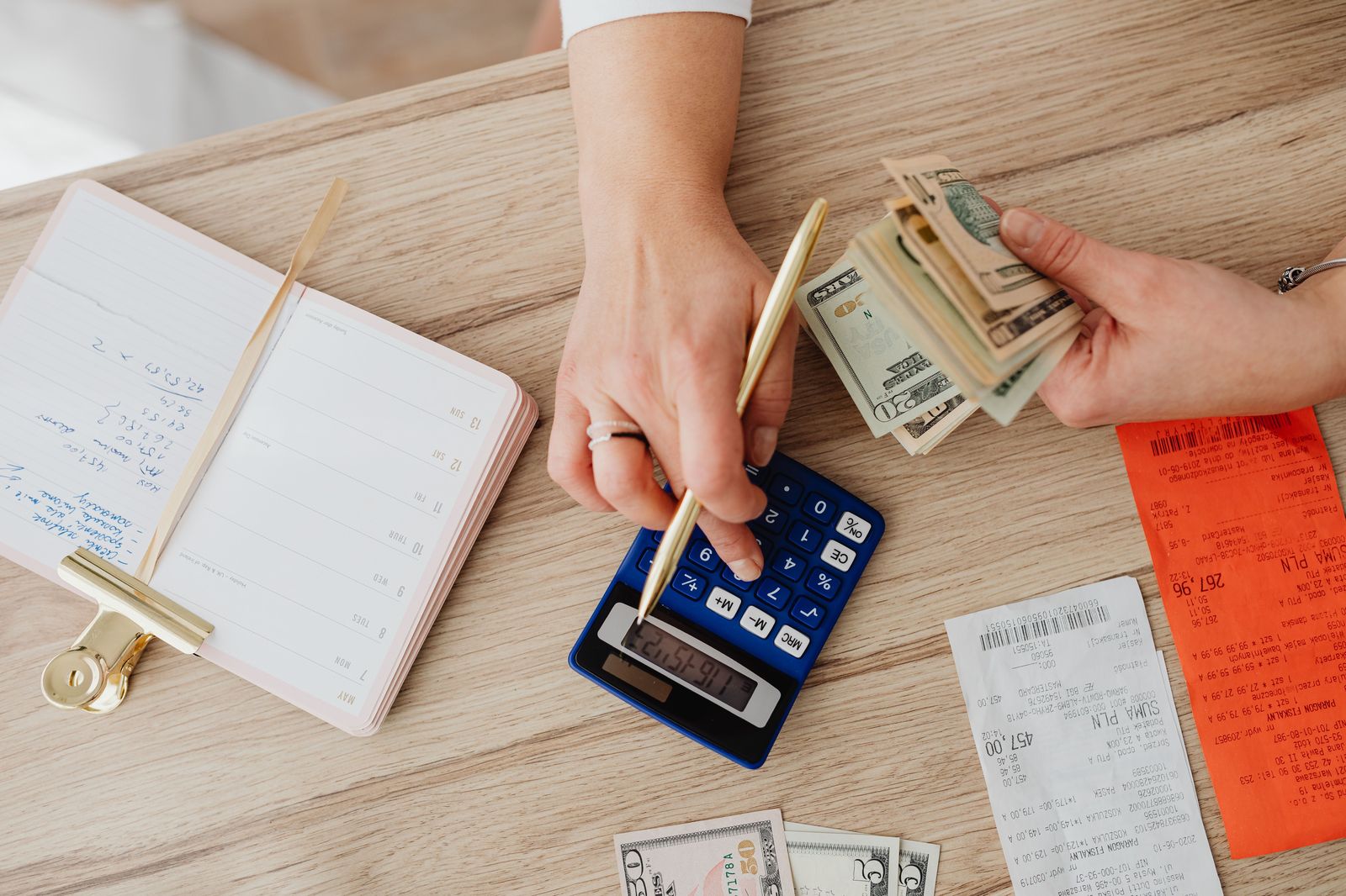 Calculator and receipt on a table while a group splits a limo bill