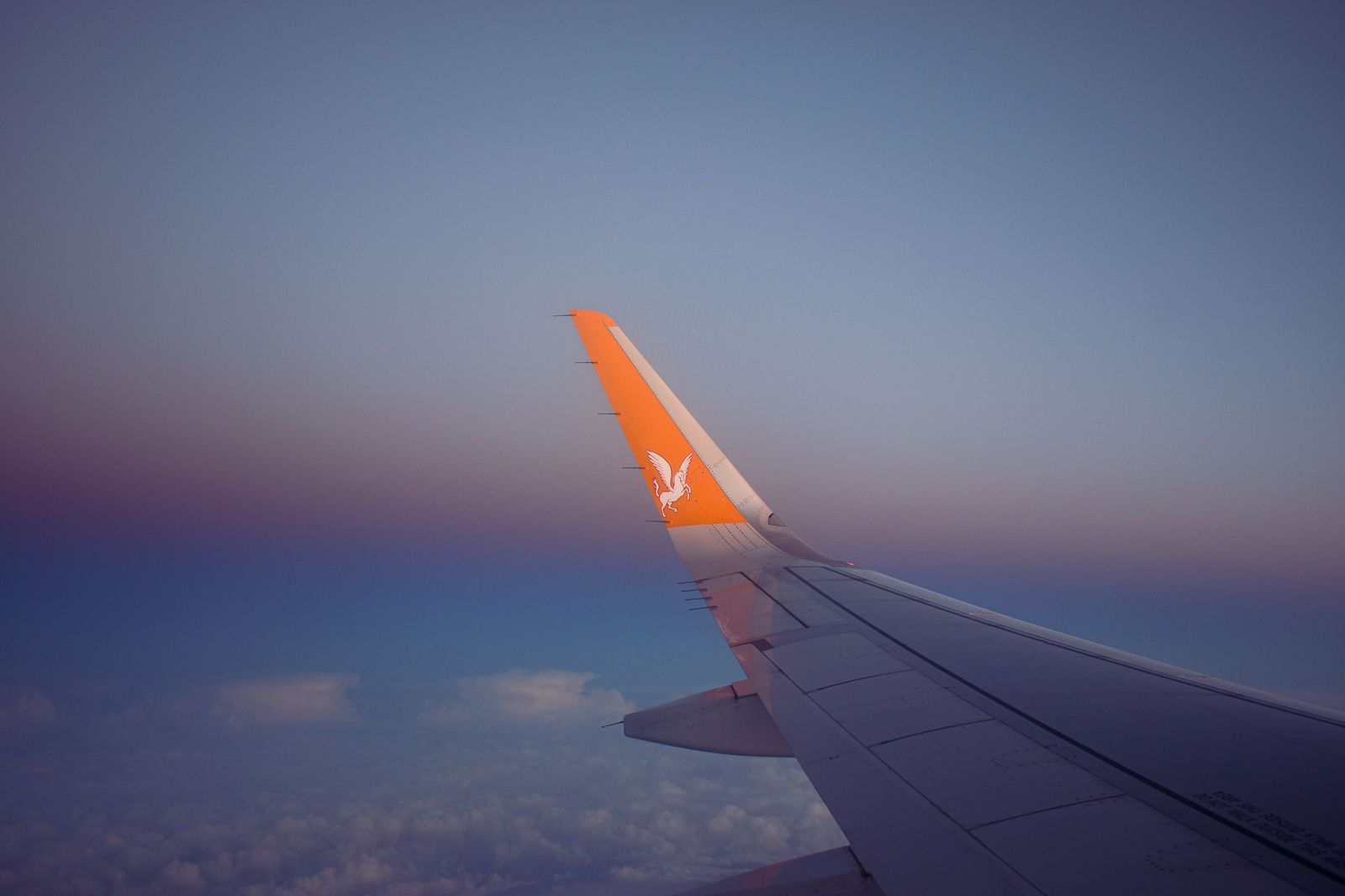 Sunrise over an aircraft wing after an early-morning departure
