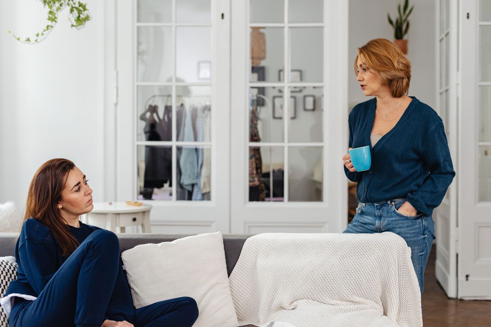 An adult daughter and her elderly mother talking through plans at the kitchen table