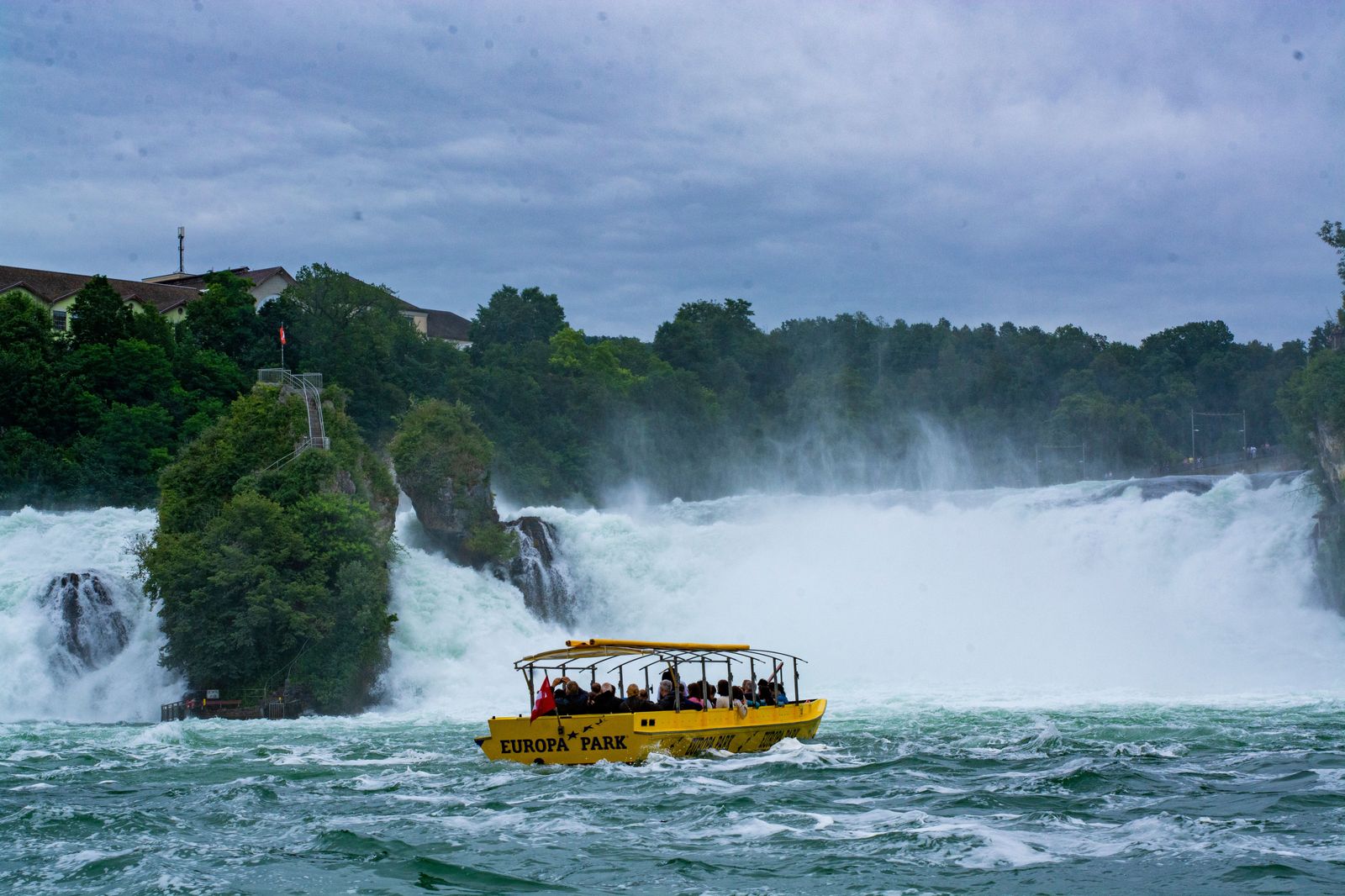 Visitors on a boat in the mist below the falls, a walk downhill from the Fallsview hotels