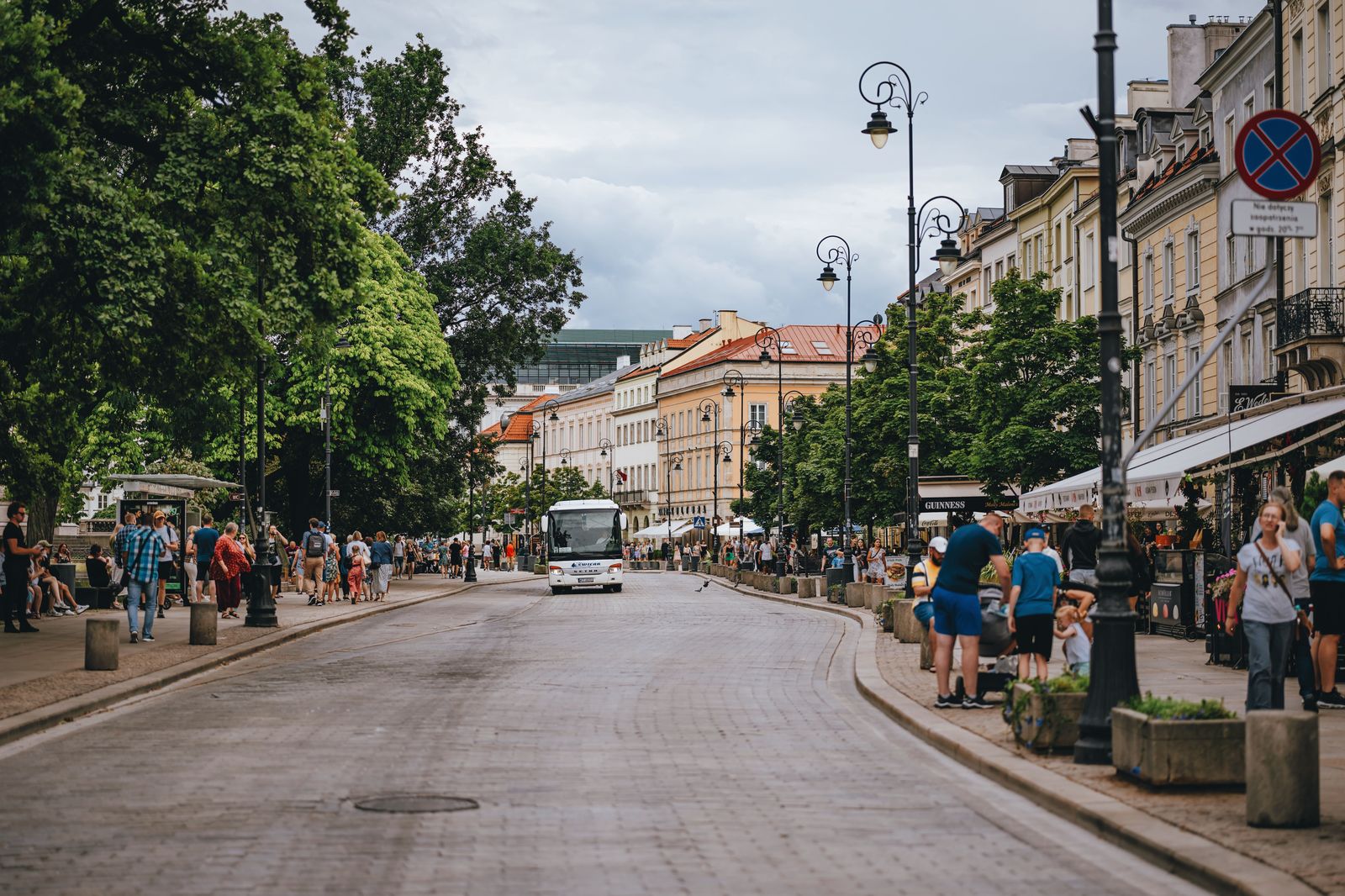 City bus on a busy main street on a summer evening