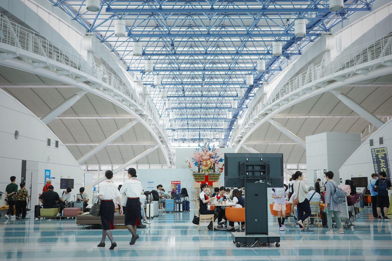 A crowded departures hall at a large international airport