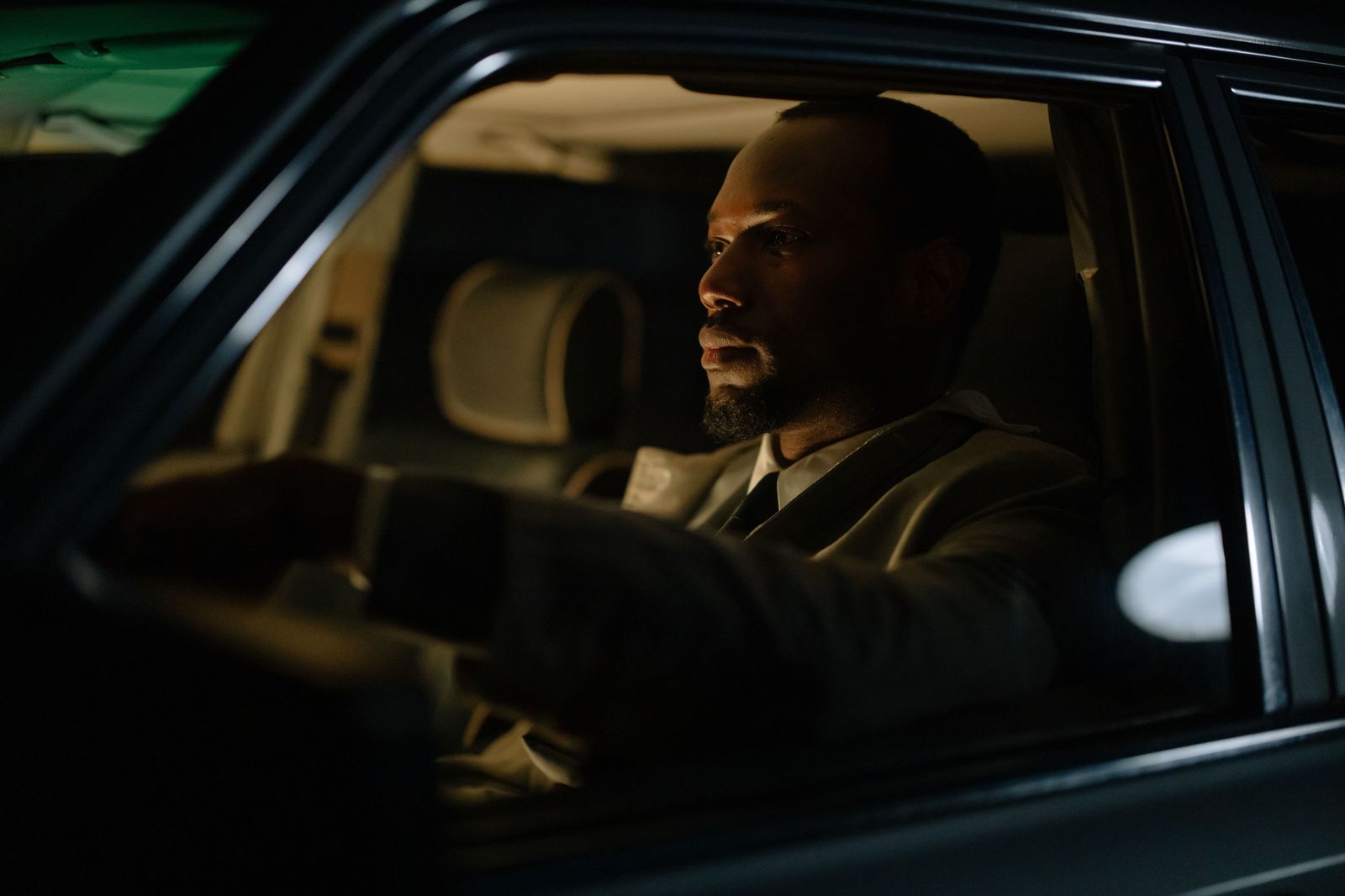 A business traveller working in the back seat during a full-day chauffeur booking