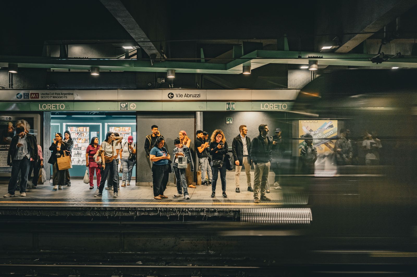 A crowded train platform in the evening after an event