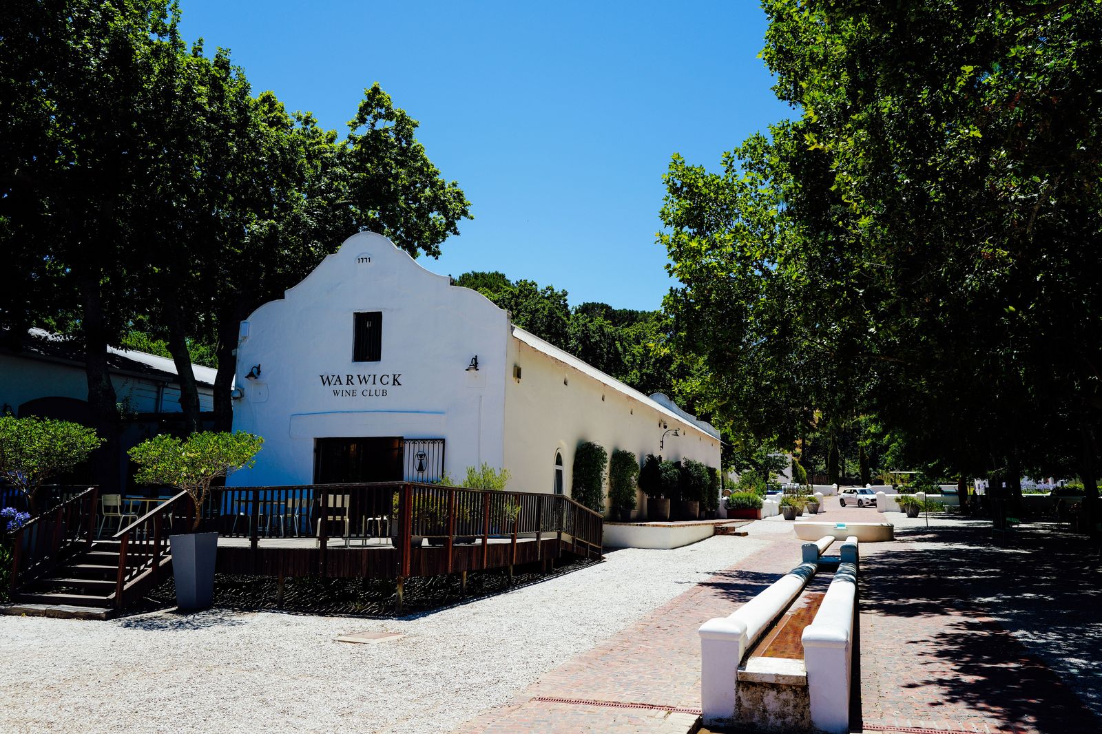 A winery tasting patio among vineyard rows in the afternoon