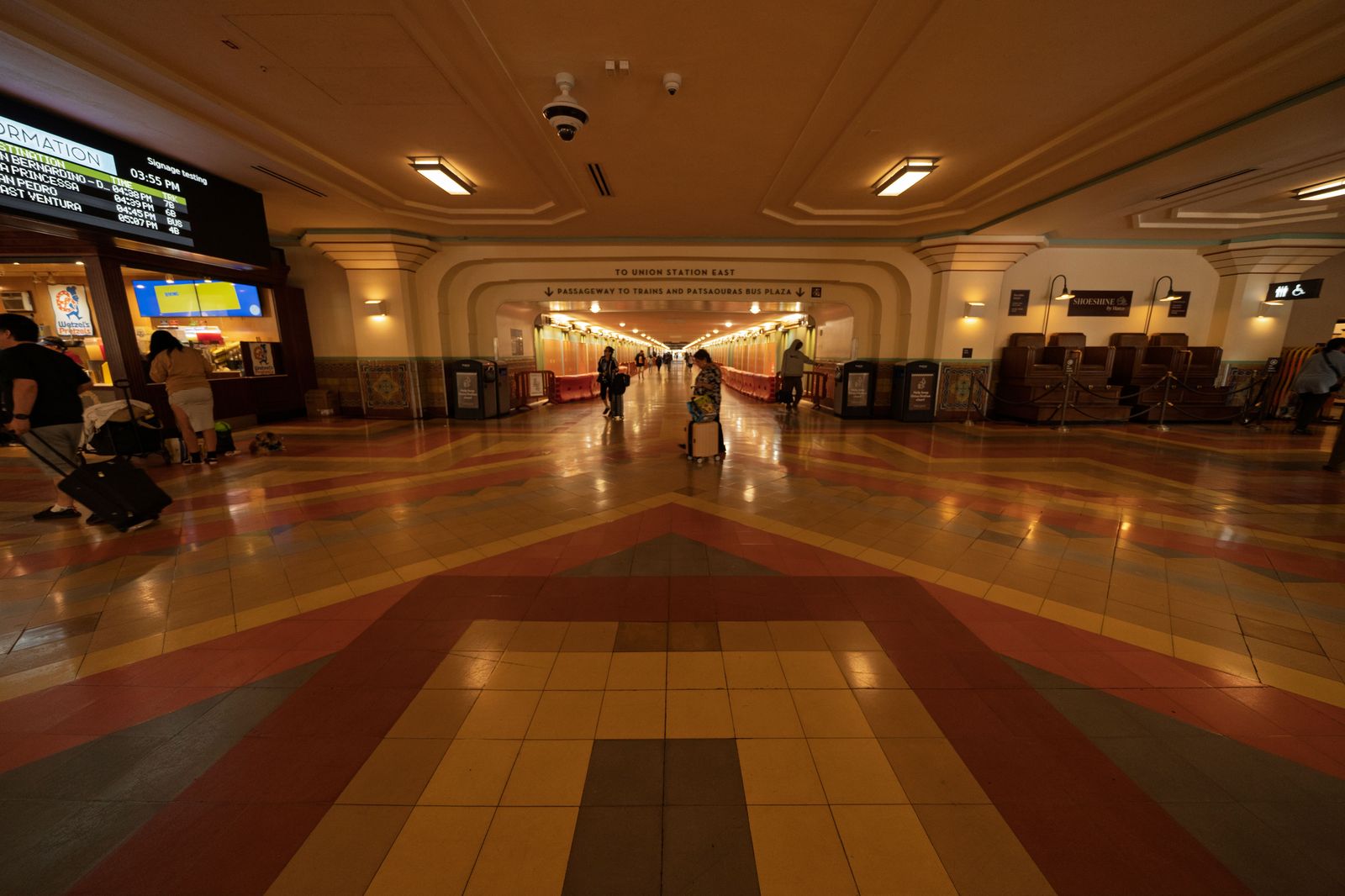 The great hall of Toronto Union Station with travellers walking through