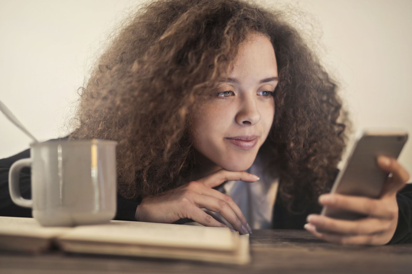 A traveller checking a booking confirmation on a phone before comparing limo quotes