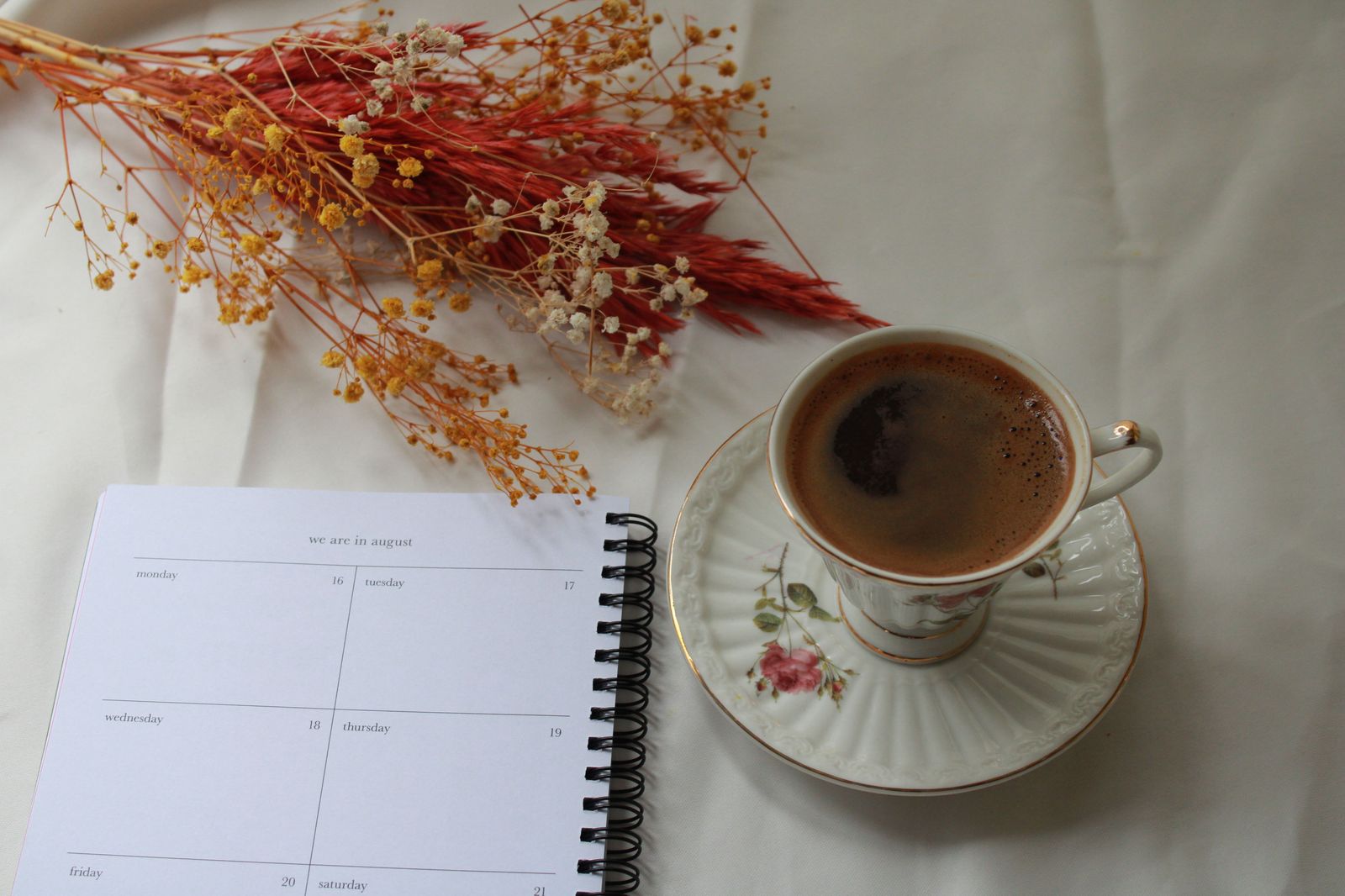 Planner writing a timeline in a notebook before booking a limousine