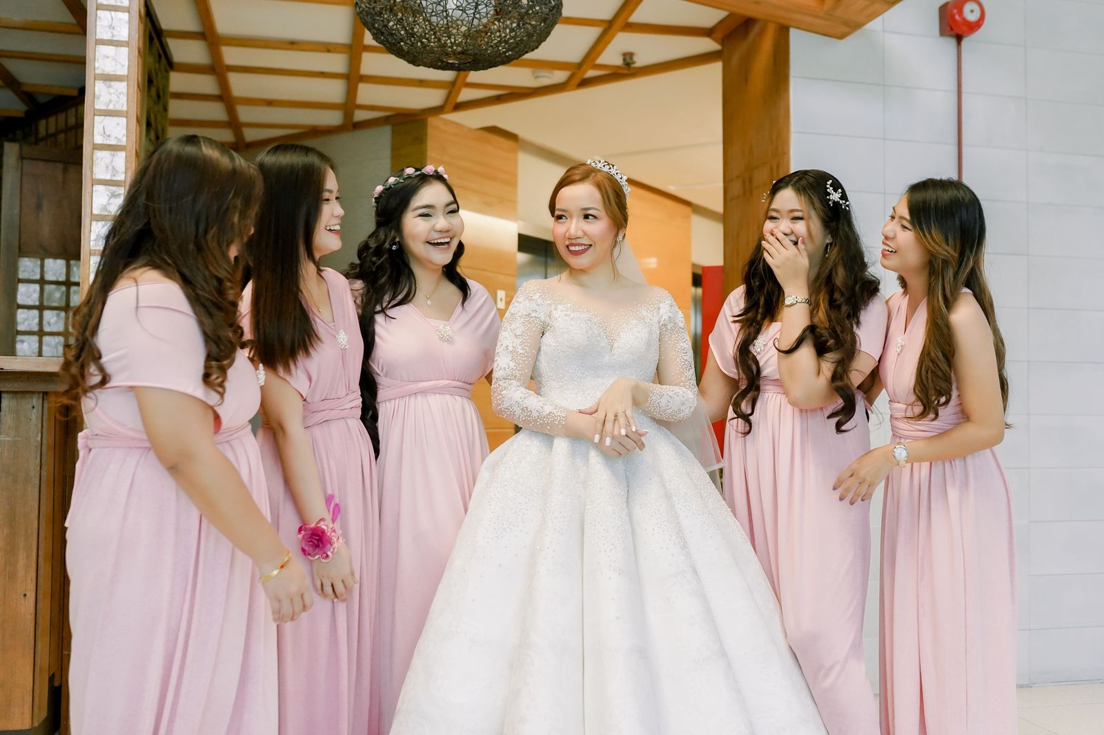 Bridesmaids in long dresses gathered together, showing how much room formal wear takes in a vehicle