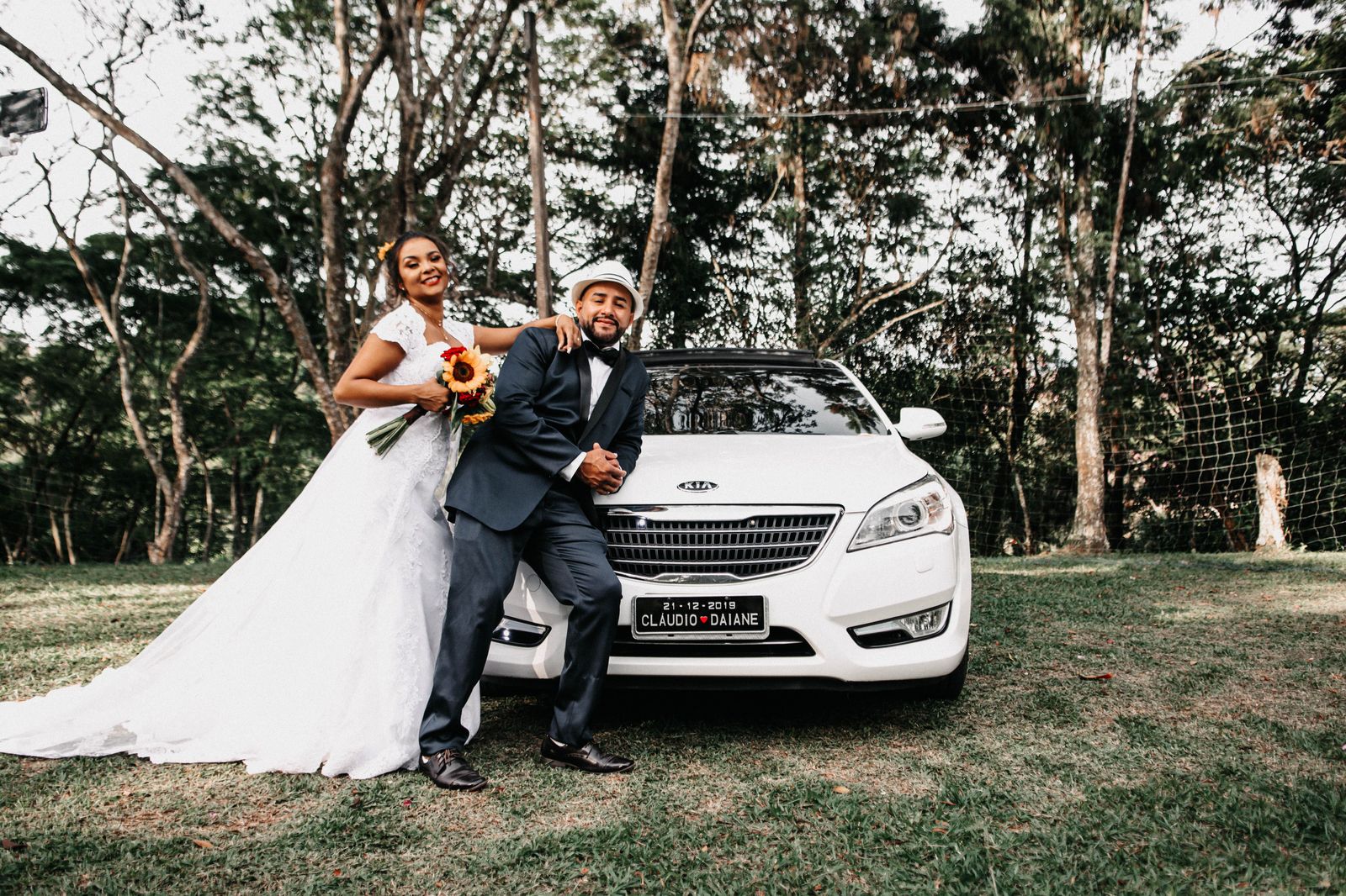 A long white stretch limousine parked outside a wedding venue waiting for the wedding party