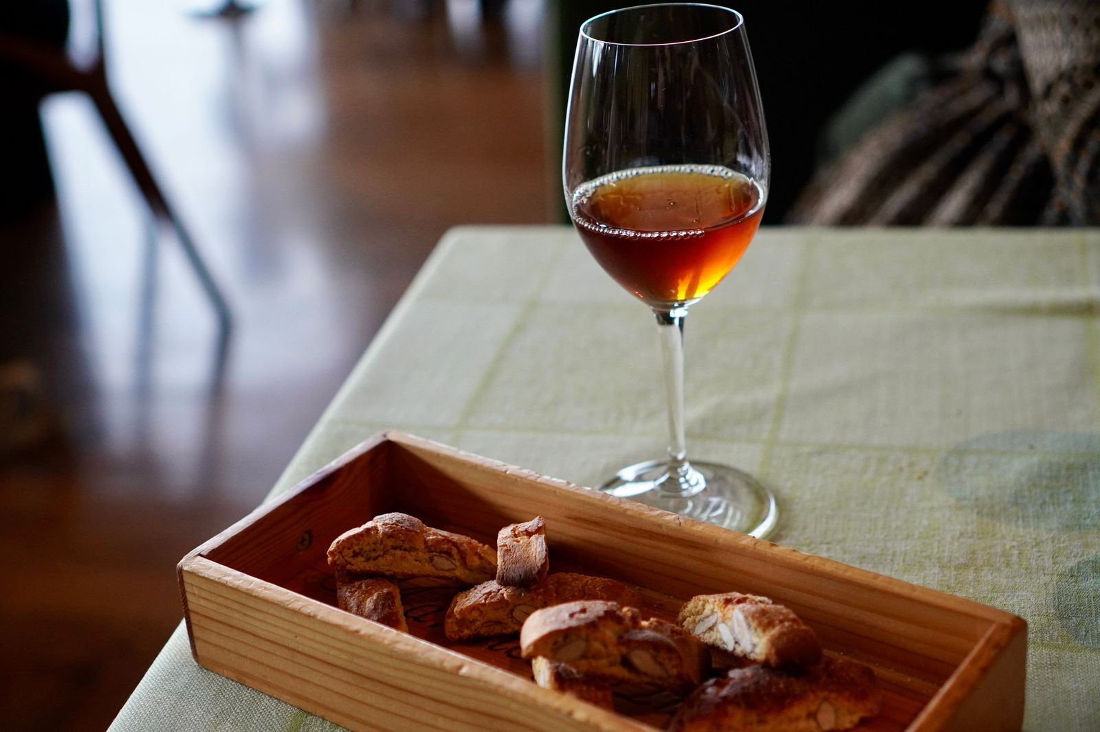 Small glass of golden dessert wine at a winery tasting
