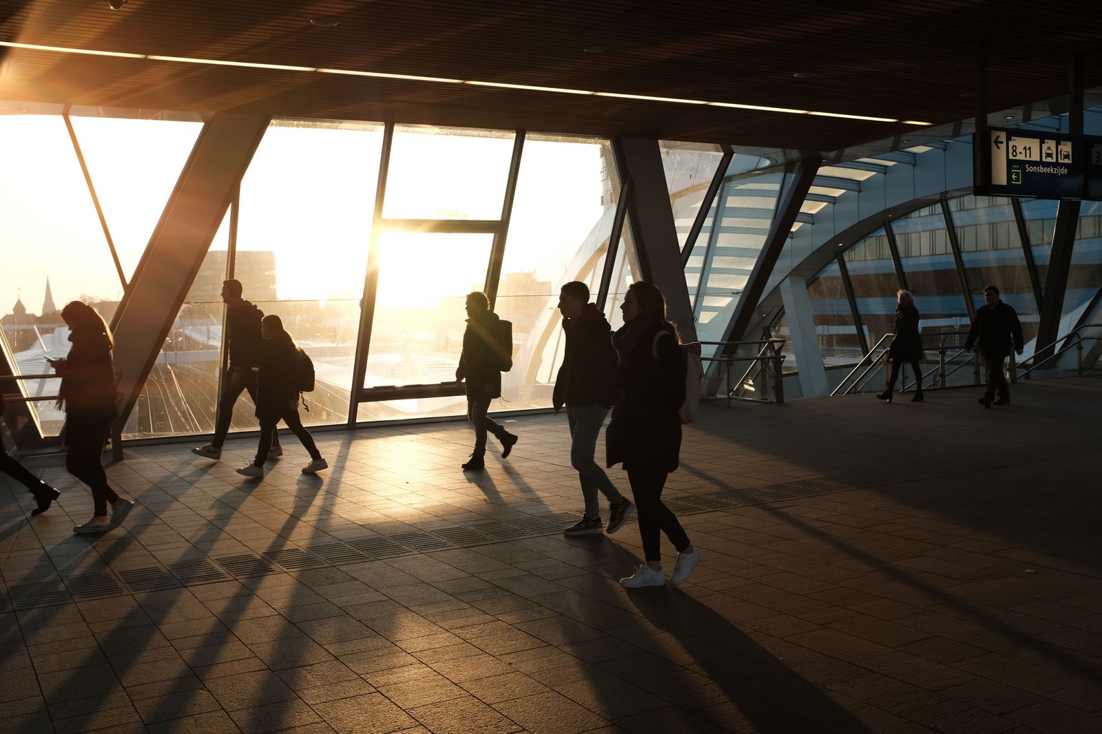 Commuters on a train platform in the early morning