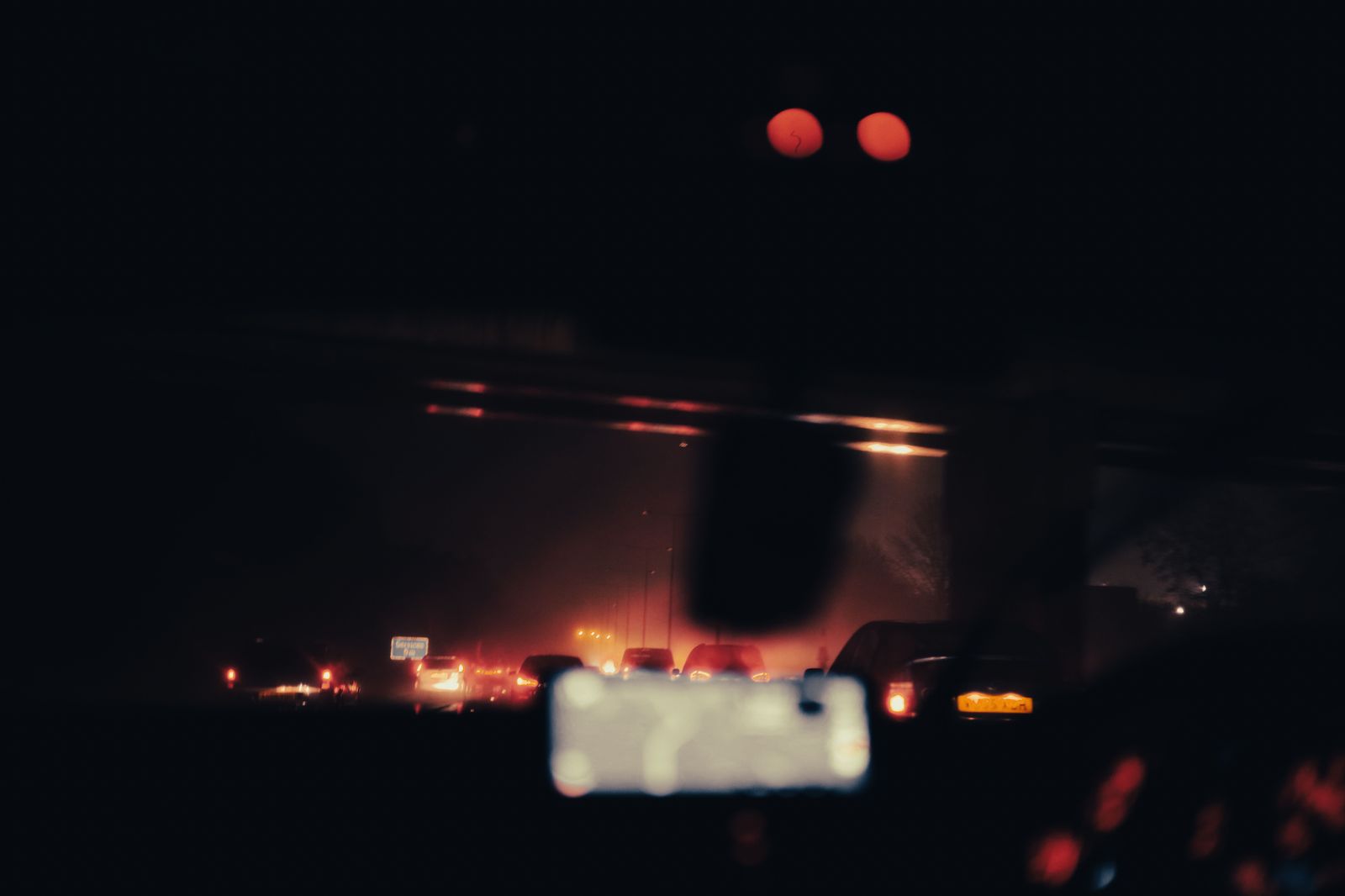 Headlights of a car on a highway at night heading home