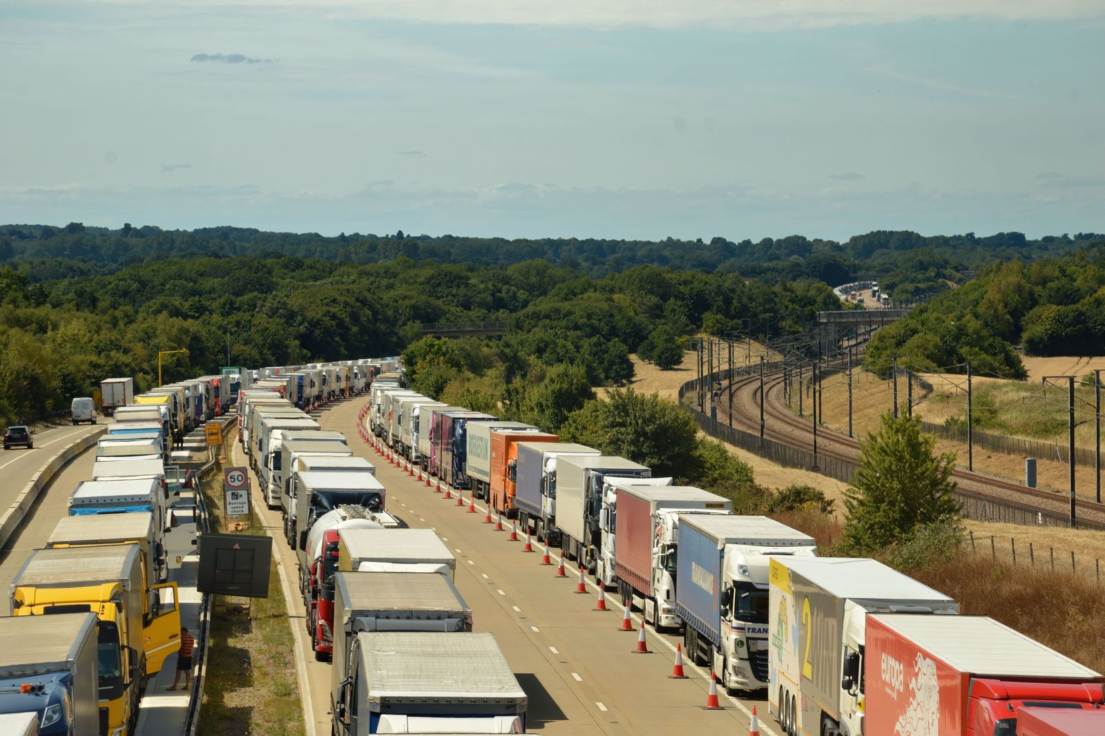Cars queue at the toll and inspection booths before an international bridge