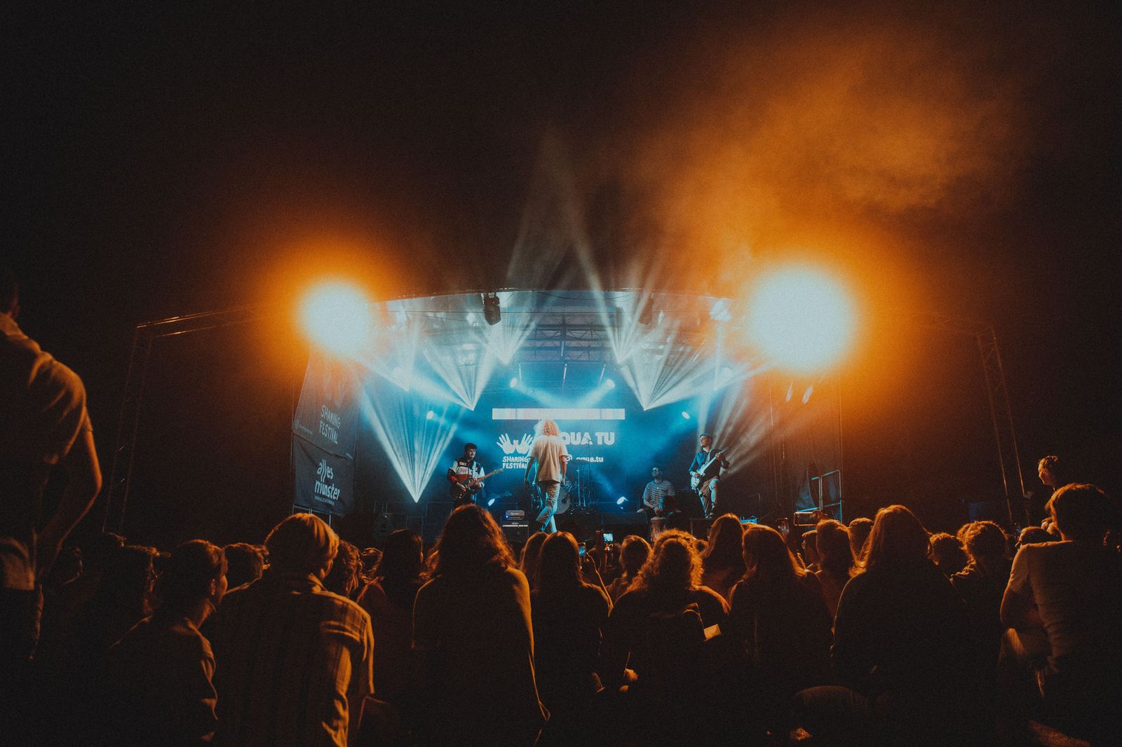 Concert crowd under stage lights at a Hamilton arena
