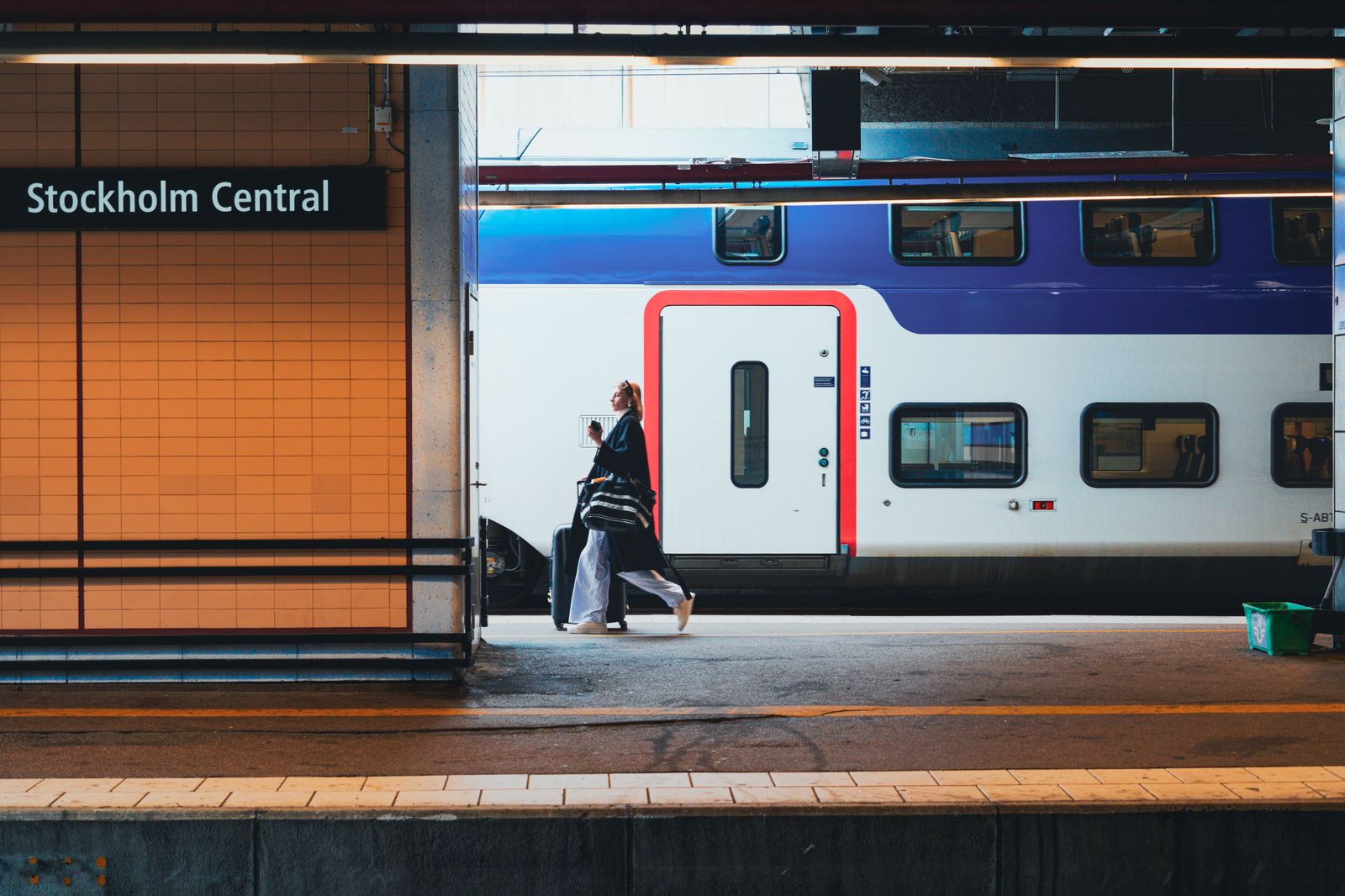 Travellers with suitcases on a station platform, the train-and-UP-Express way to Pearson