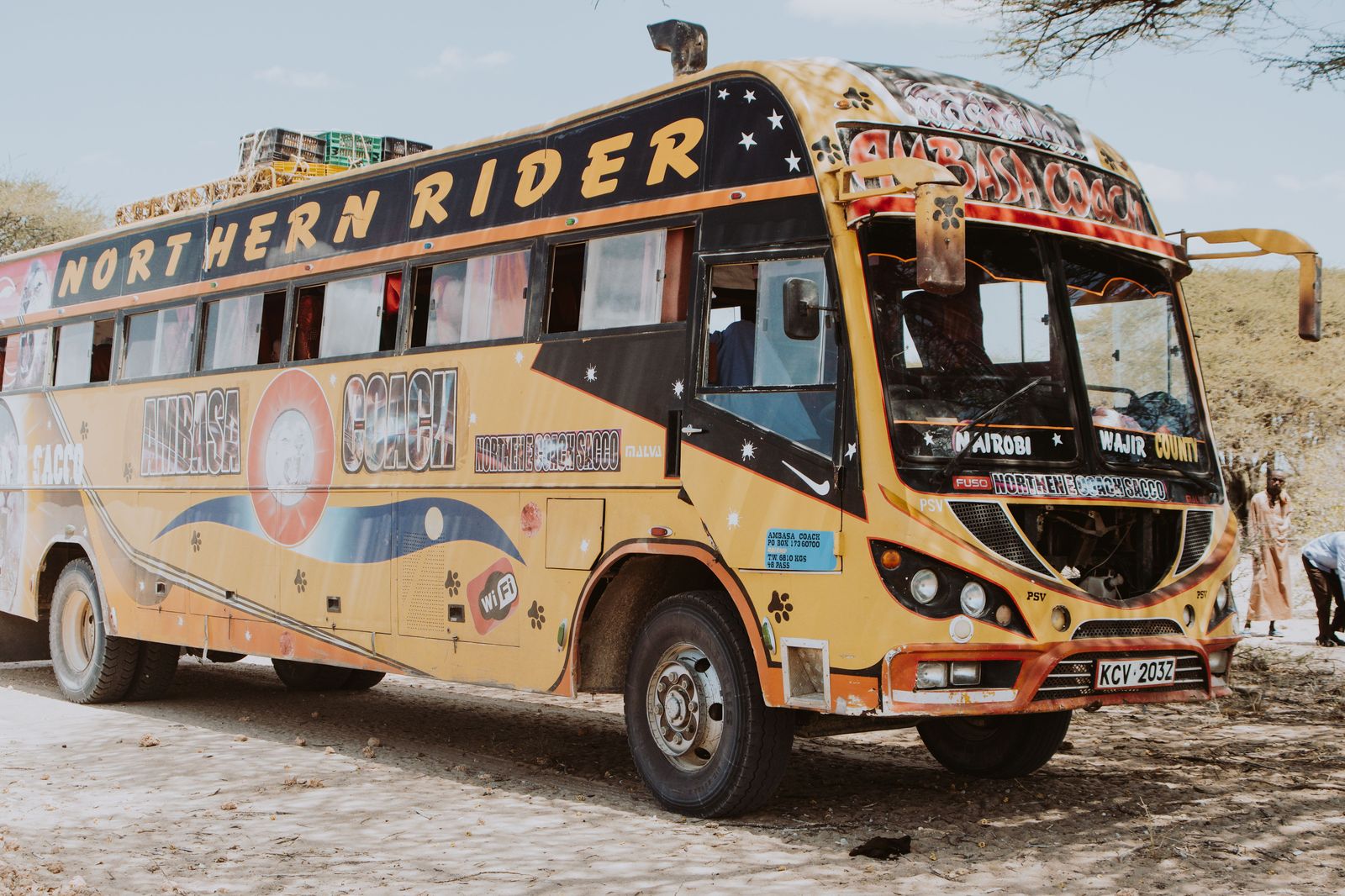 A coach on a northern highway lined with forest, the bus route many travellers take to Muskoka