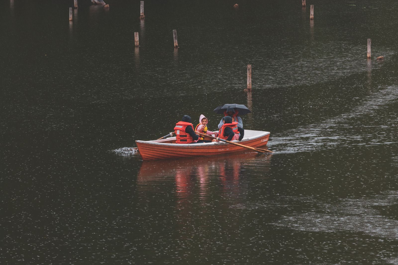 A family in rain ponchos on a boat near the foot of Niagara Falls