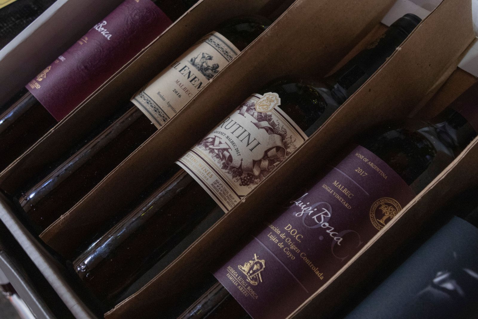Wine cases packed flat in a vehicle trunk ahead of an airport transfer
