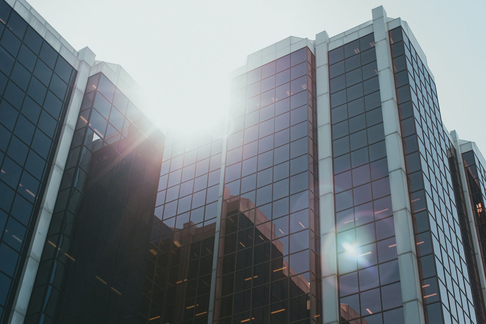 A glass office building in a business park in the morning, a short drive from Oakville's hotels