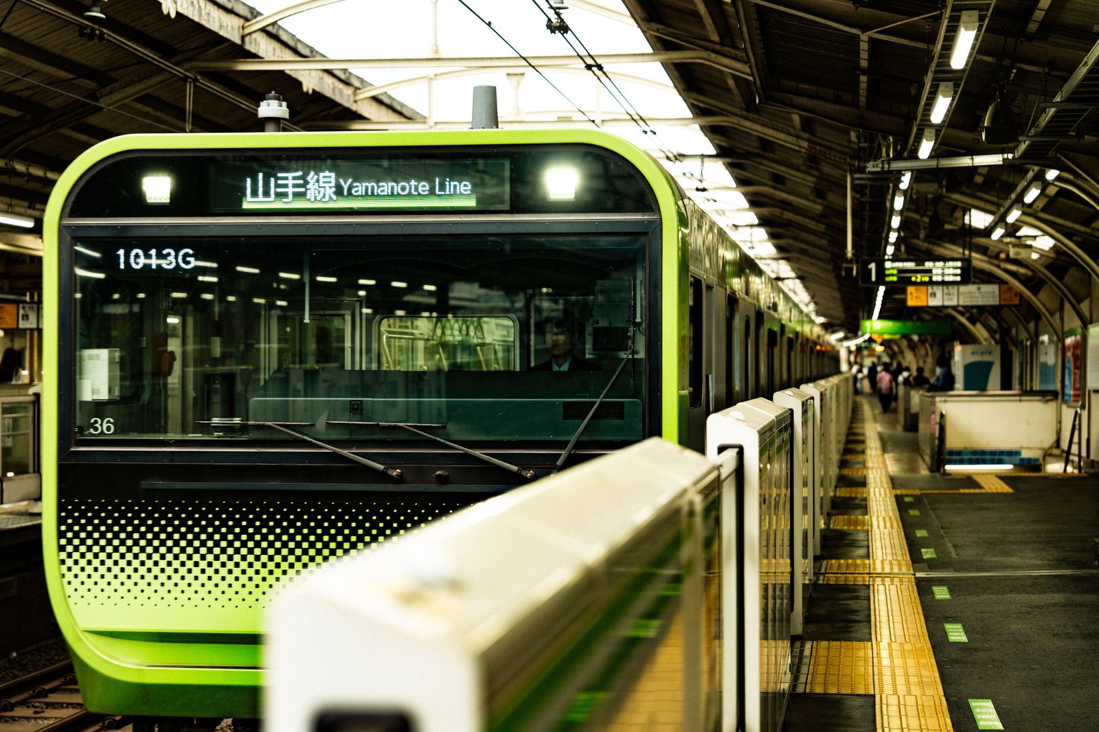 A commuter train arriving at a station platform, an alternative to driving from Oakville to Toronto