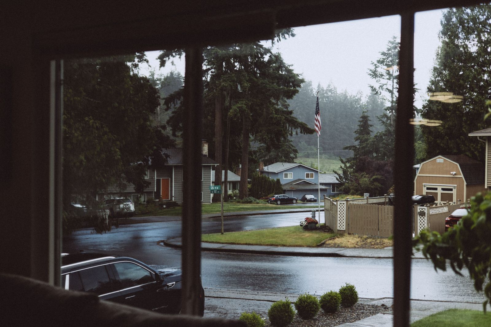A black SUV waiting in a suburban driveway early in the morning
