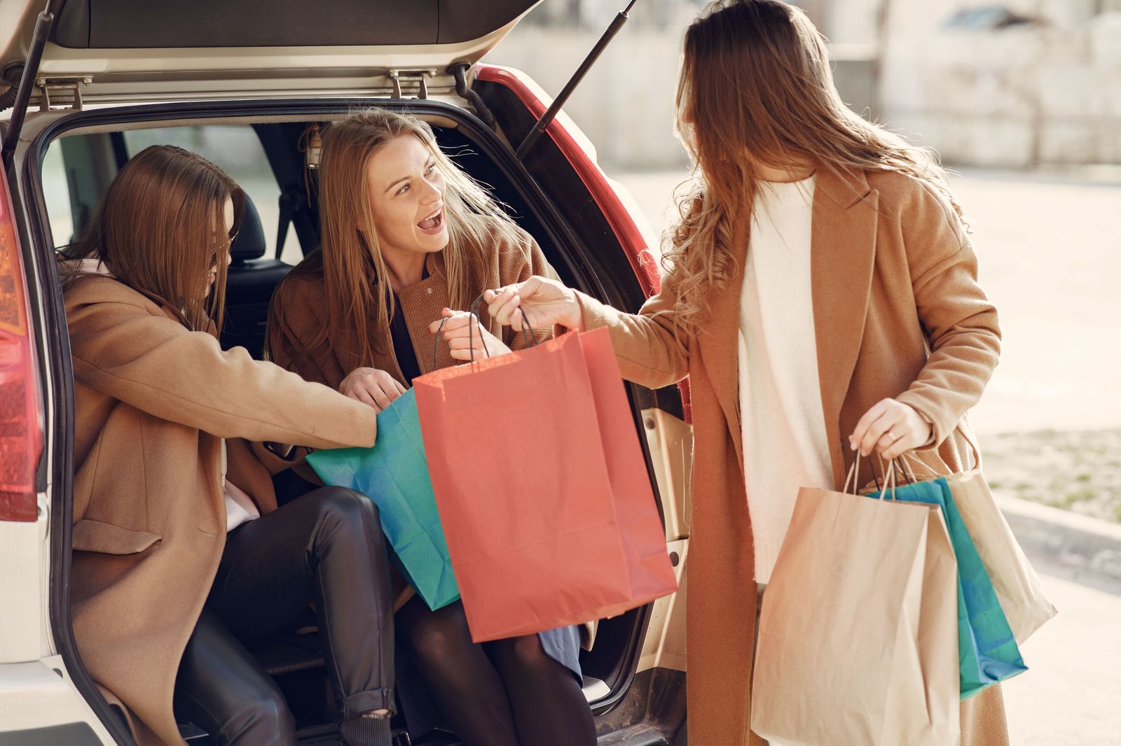 Shopping bags loaded into the trunk of a car at the end of a shopping day