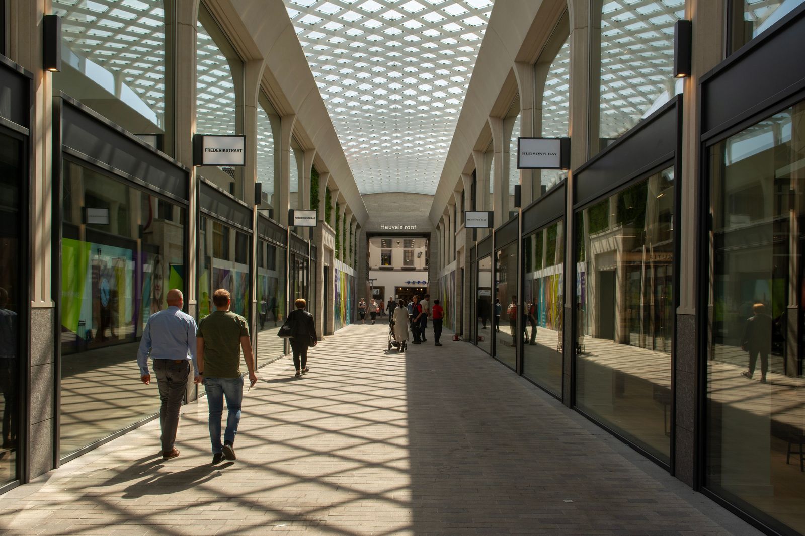 An outdoor shopping centre walkway lined with stores