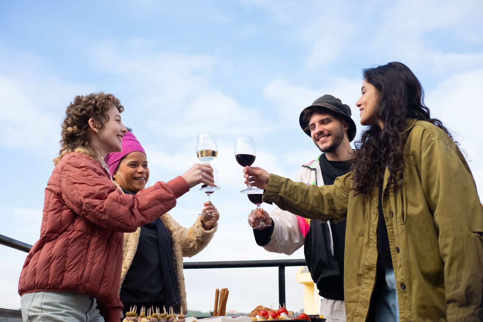 A group raising glasses at a winery table during a Niagara day out by party bus