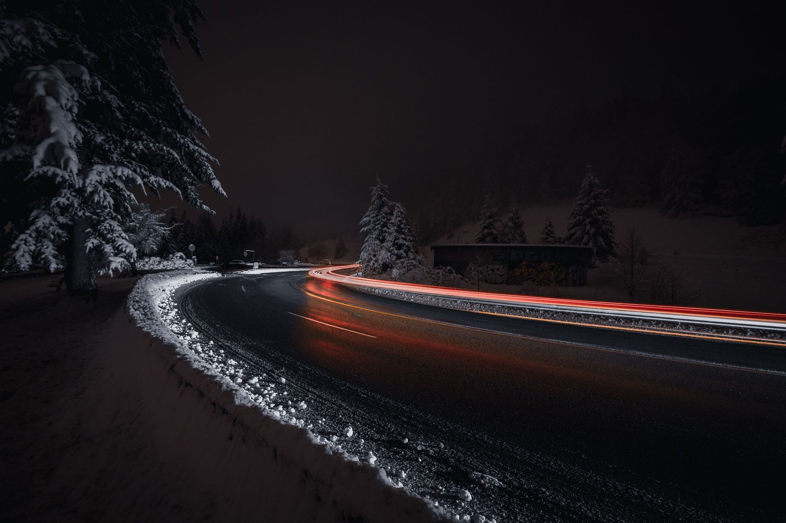 A snowy highway at night, the reason many winter travellers stay near Pearson the night before