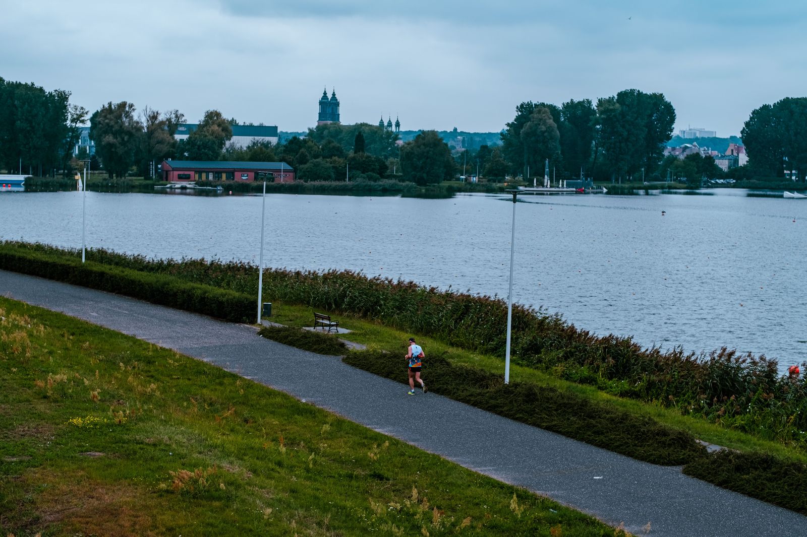 Runners on a lakeside path on a cool autumn morning