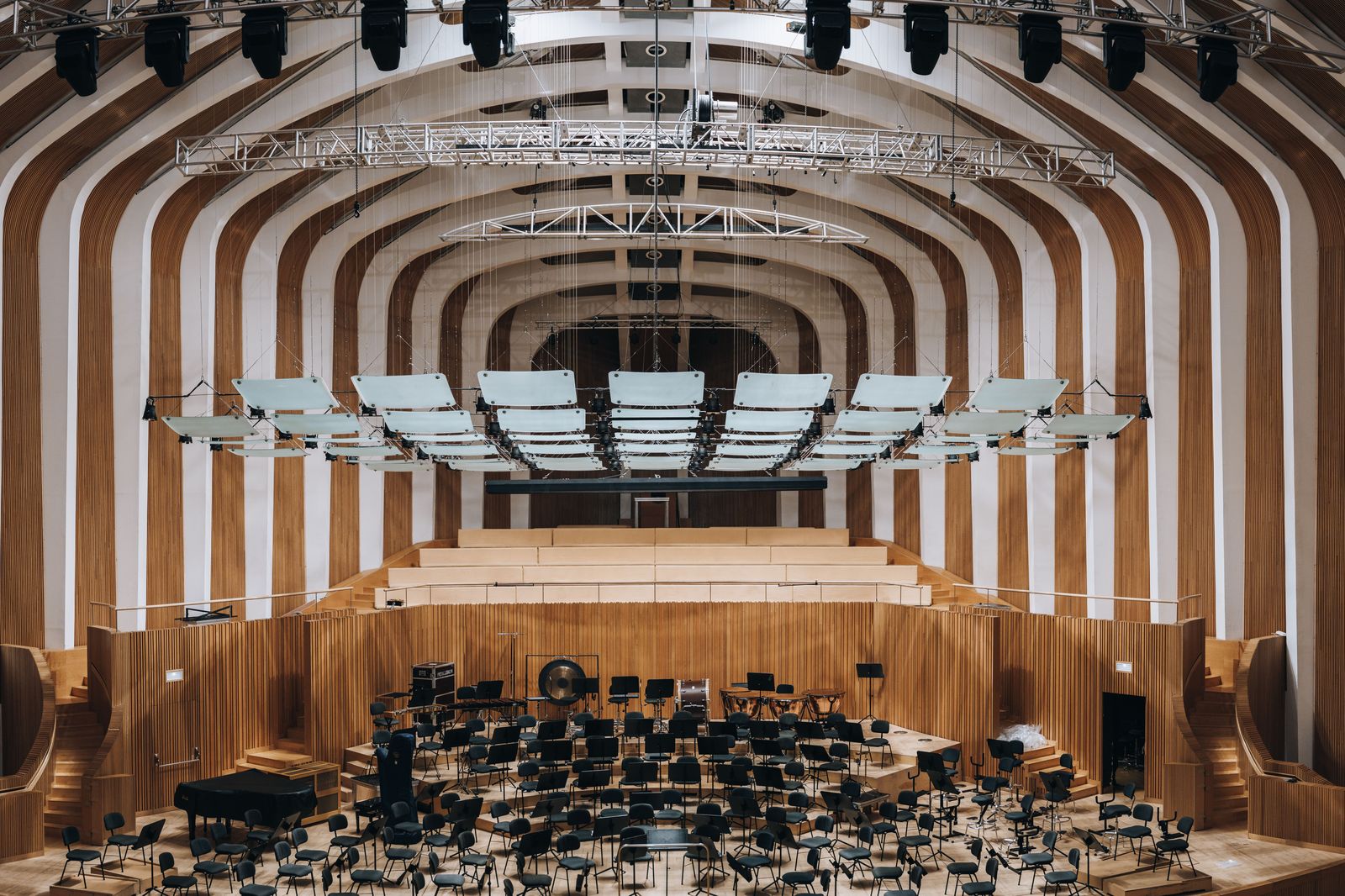 An orchestra on stage in a concert hall during an evening performance