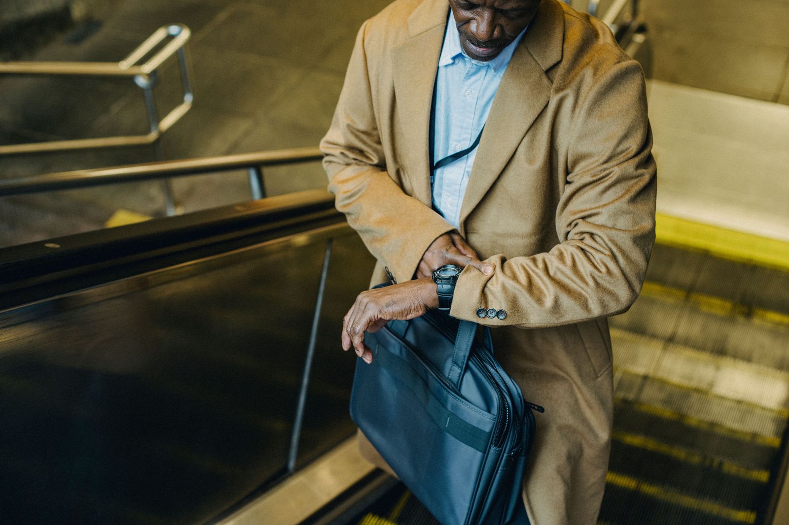 A traveller checking the time in an airport terminal before a flight
