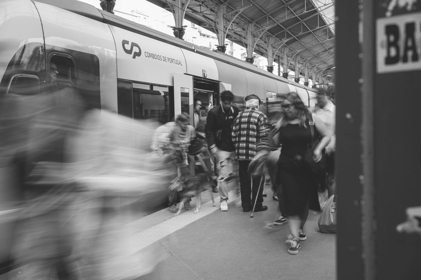 Commuters on a train platform on a summer evening