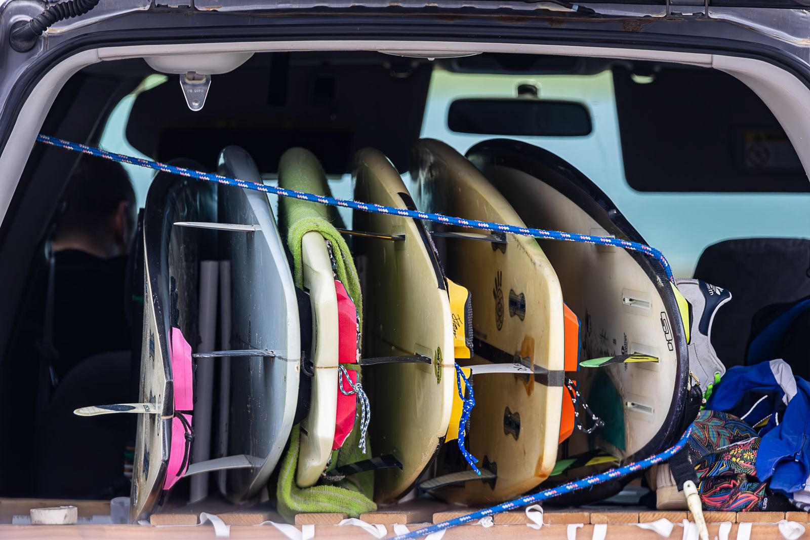 Suitcases and bags packed neatly in the rear of a passenger van