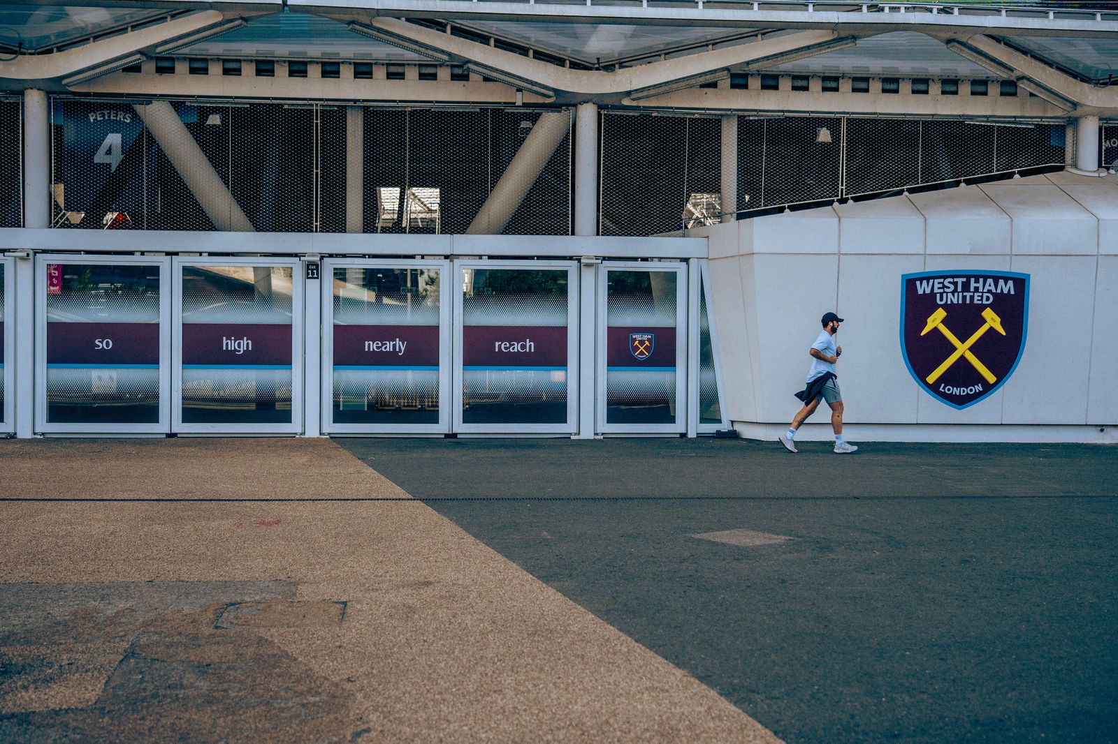 Fans walking along a neighbourhood street toward Hamilton Stadium before a game